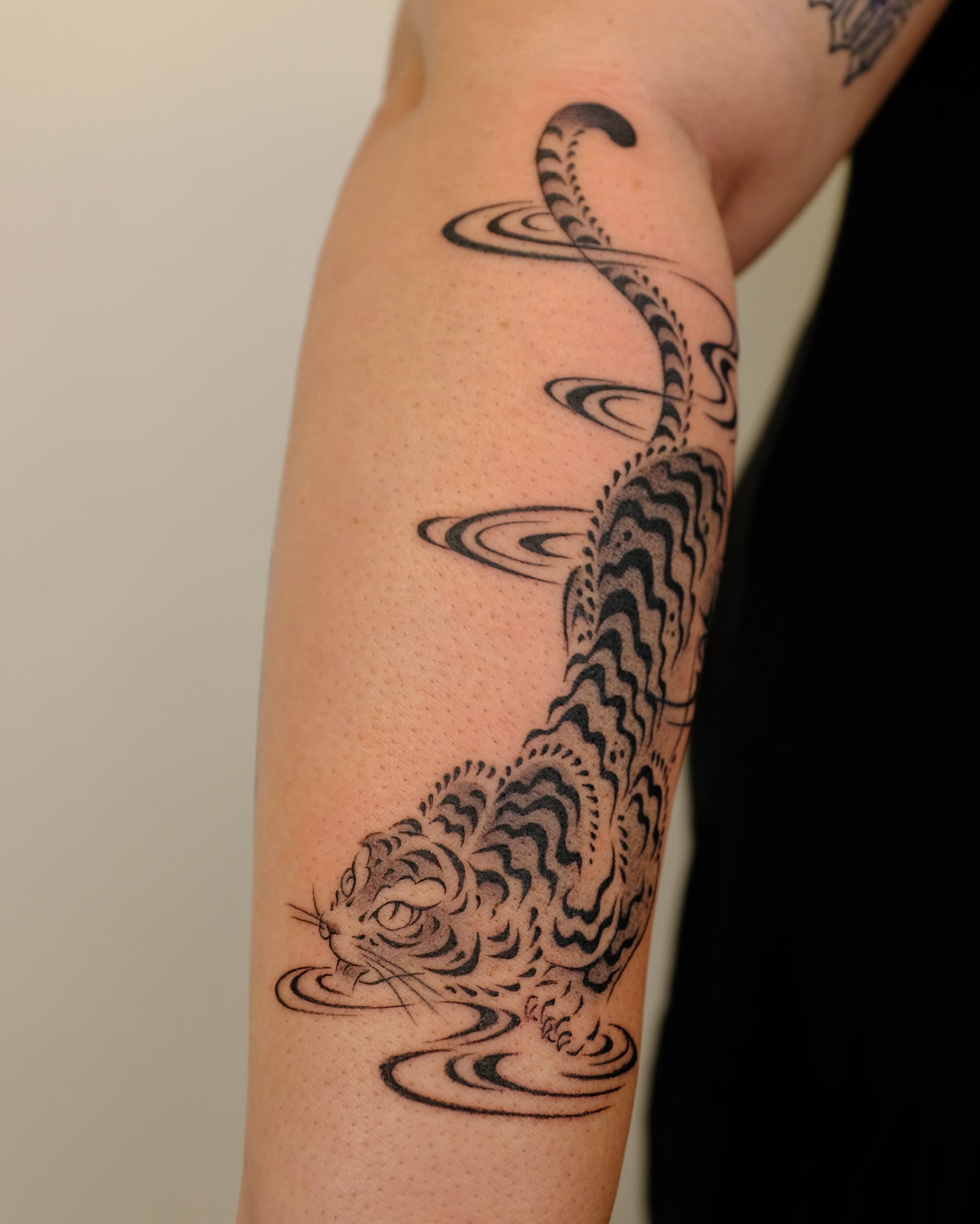 Tiger black and grey tattoo on the forearm by Xiao Lun