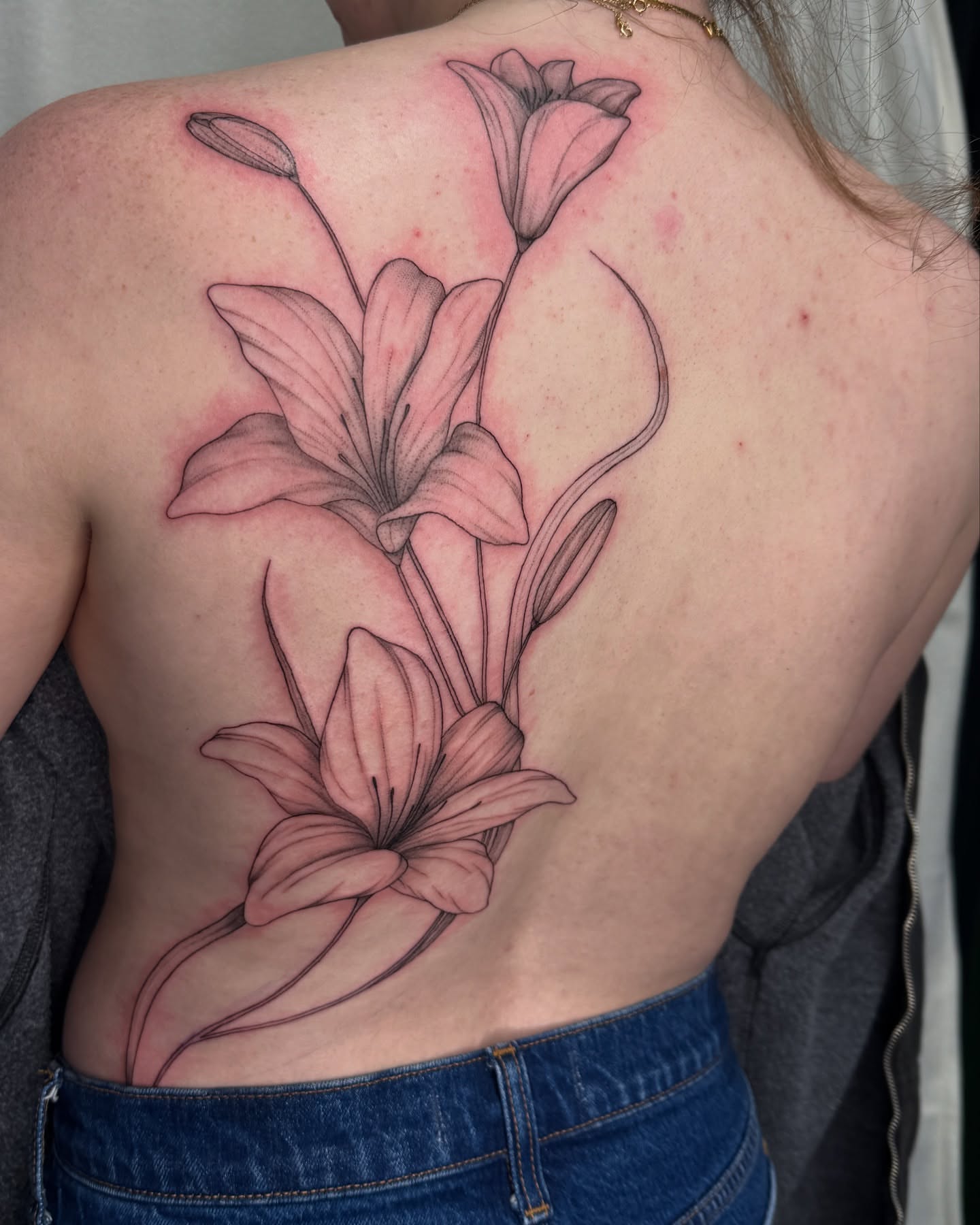 Lilies black and grey tattoo on the back by elena