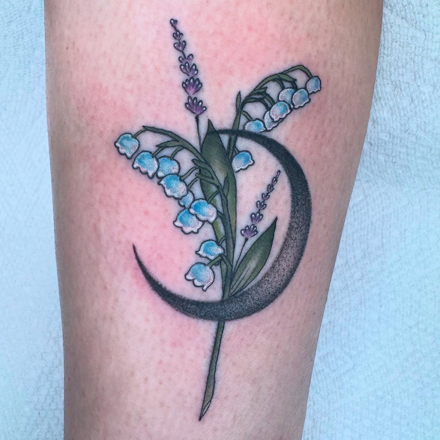 Lily of the valley and crescent moon dotwork tattoo on the forearm by Lisa Del Toro