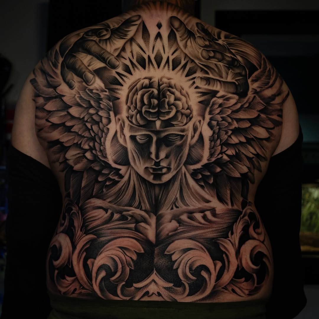 Angelic figure with brain and hands realism tattoo on the back by Apolo