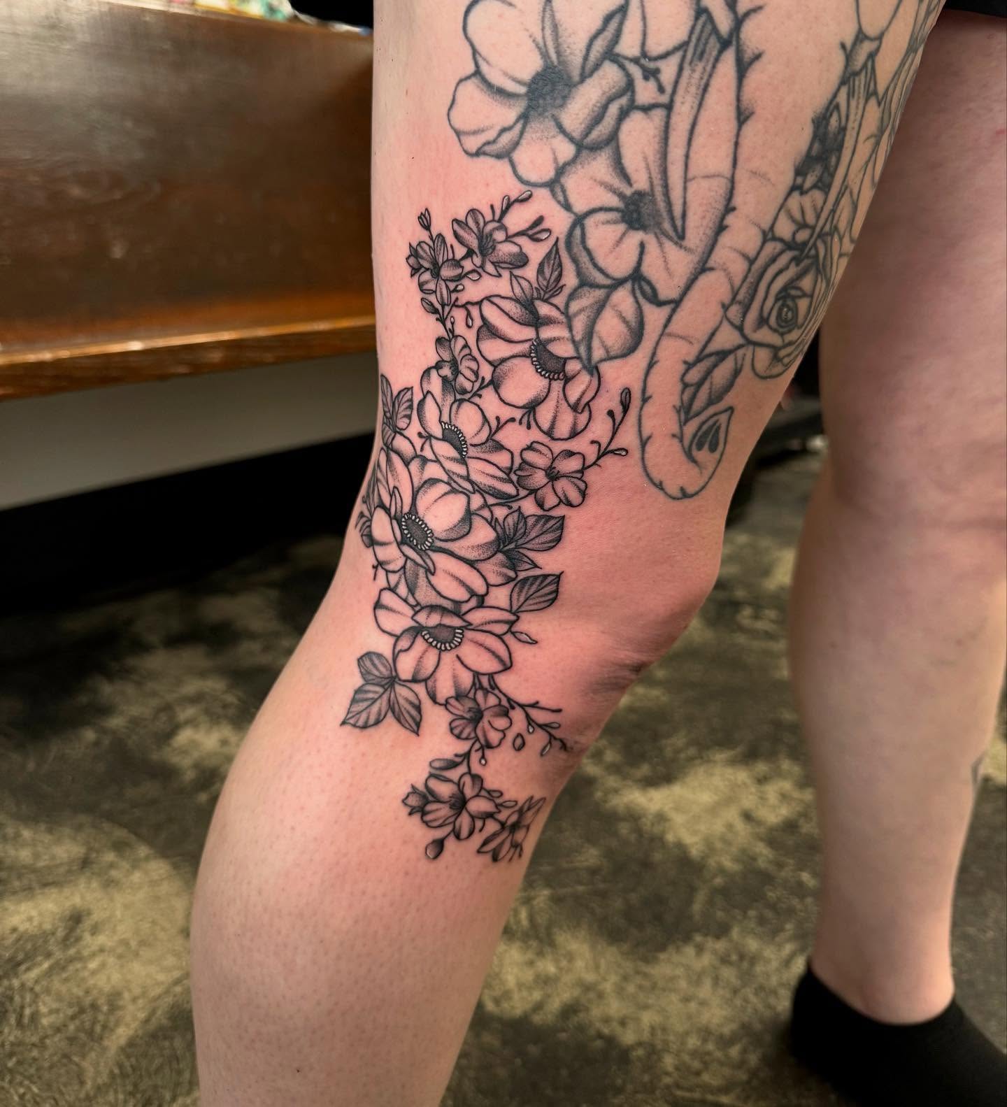 Floral bouquet black and grey tattoo on the thigh by Kylee langford 🧿