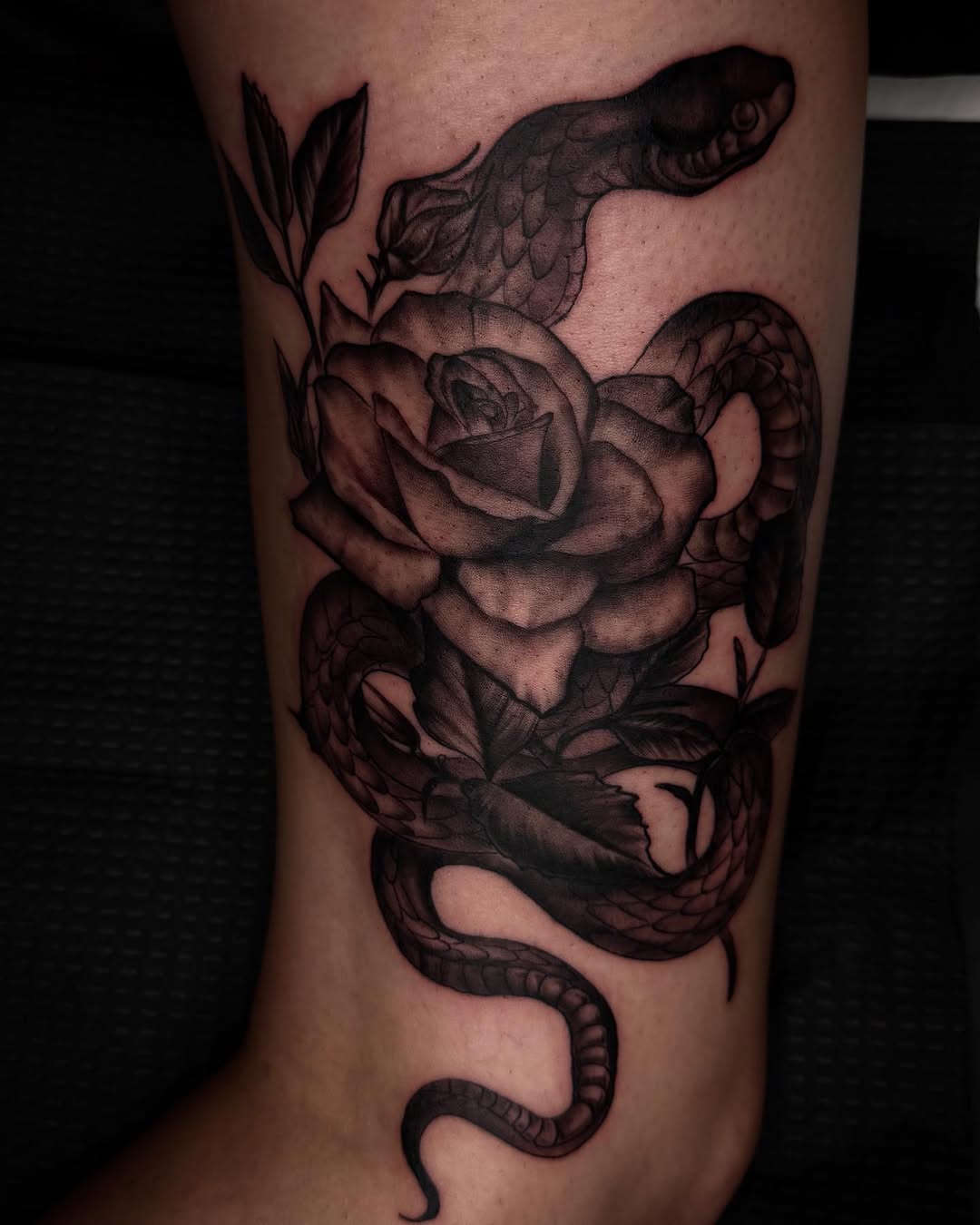 Snake and rose dotwork tattoo on the forearm by Aaron Ysidro