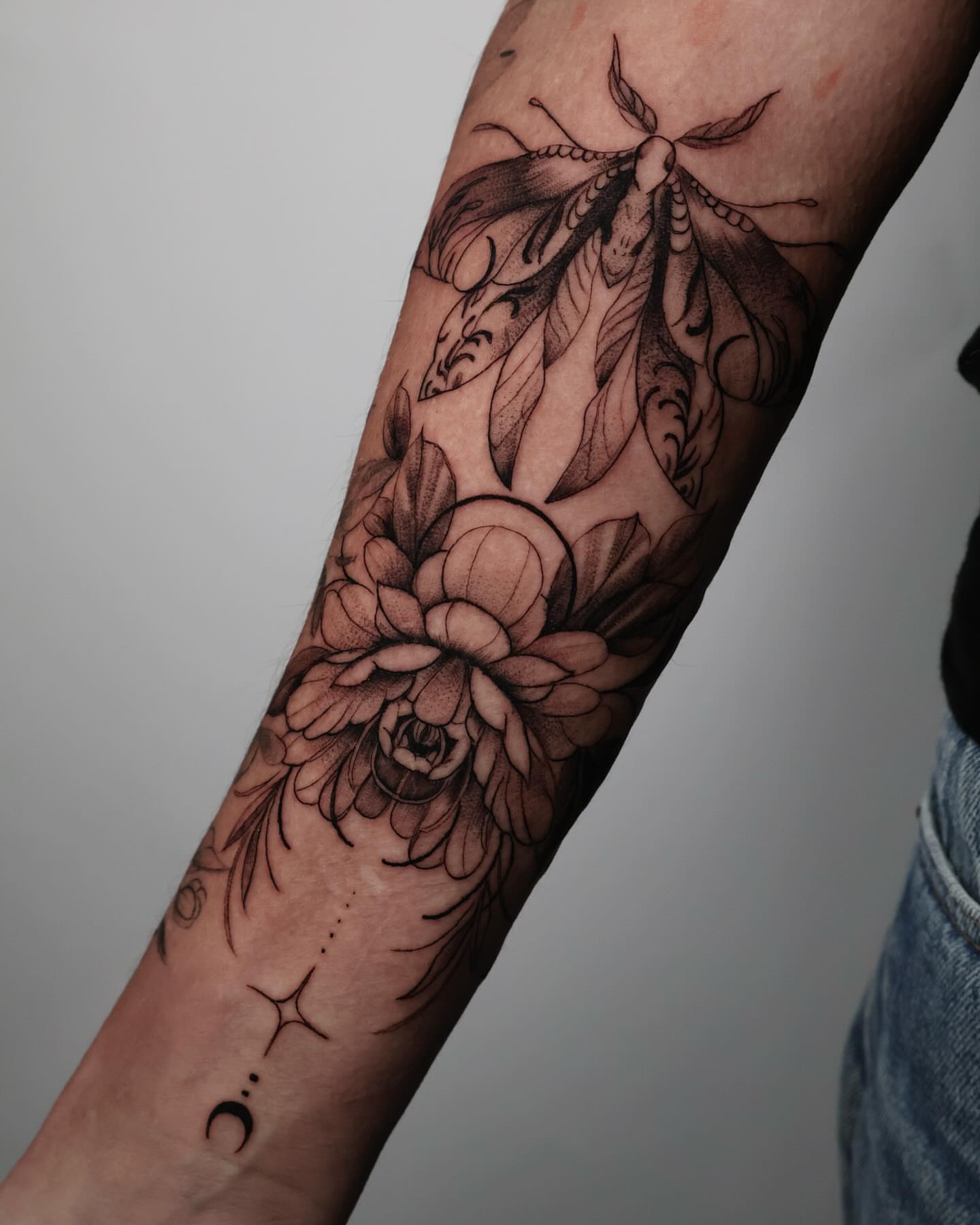 Flower moth realism tattoo on the forearm by Stephanie Pedraza