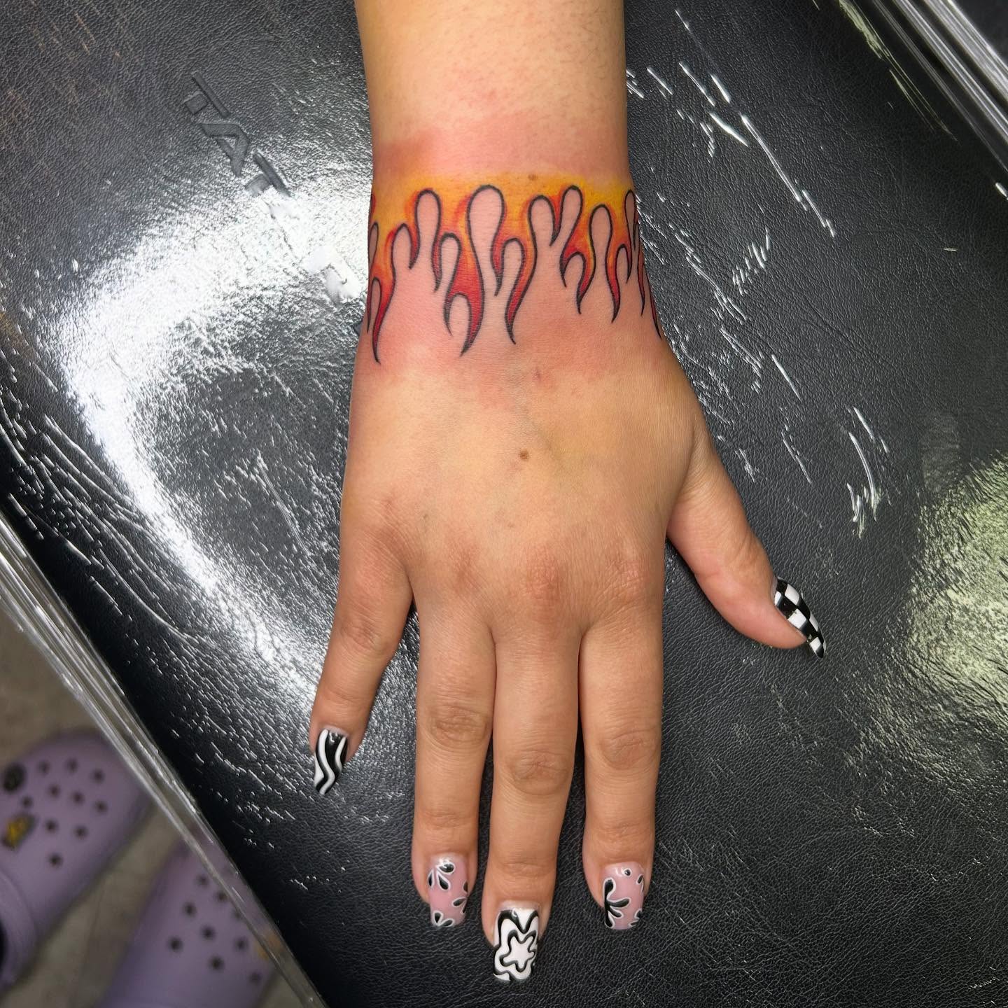 Flames American traditional tattoo on the forearm by Victoria Mendez