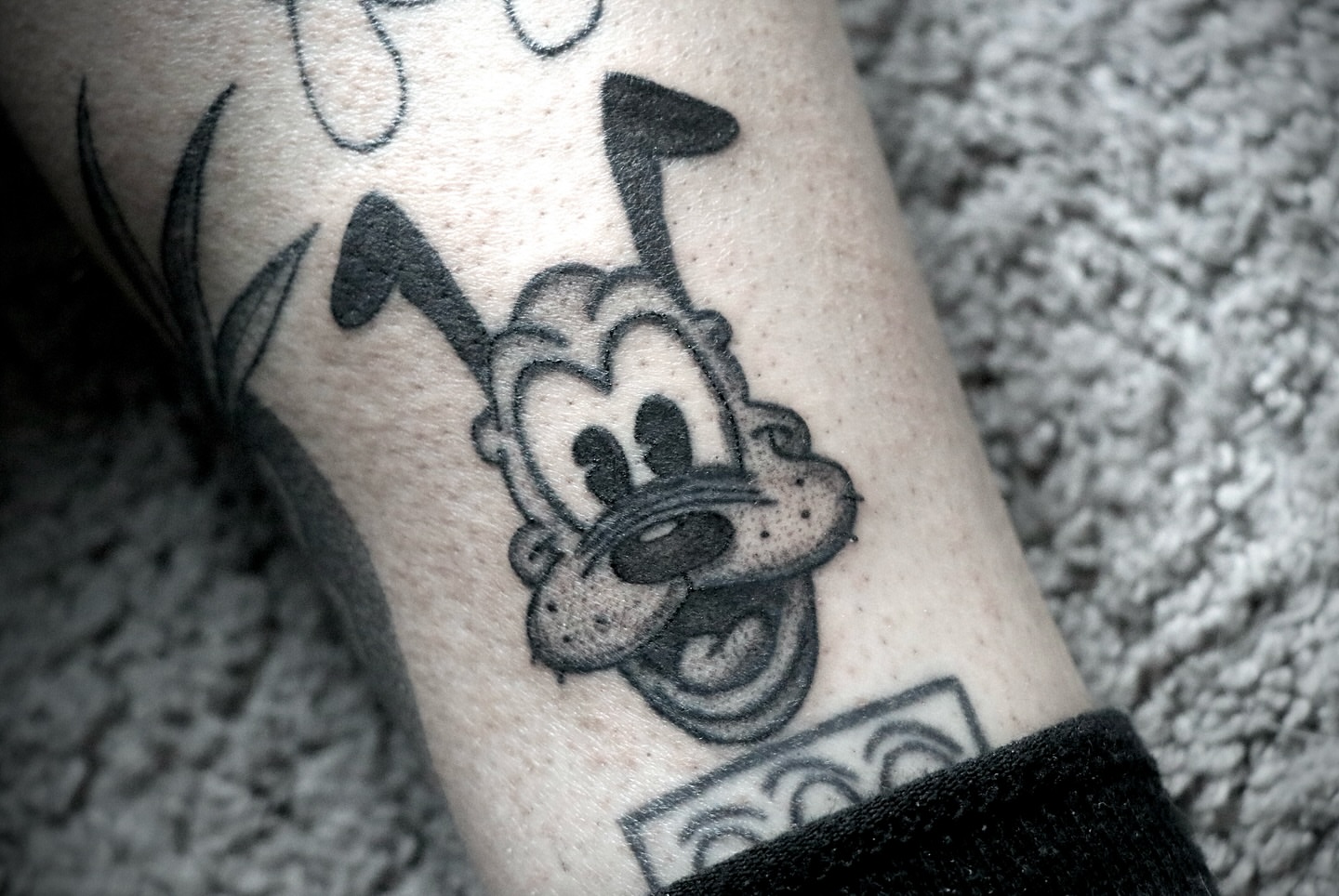 Goofy black and grey tattoo on the forearm by Love 🥀 222