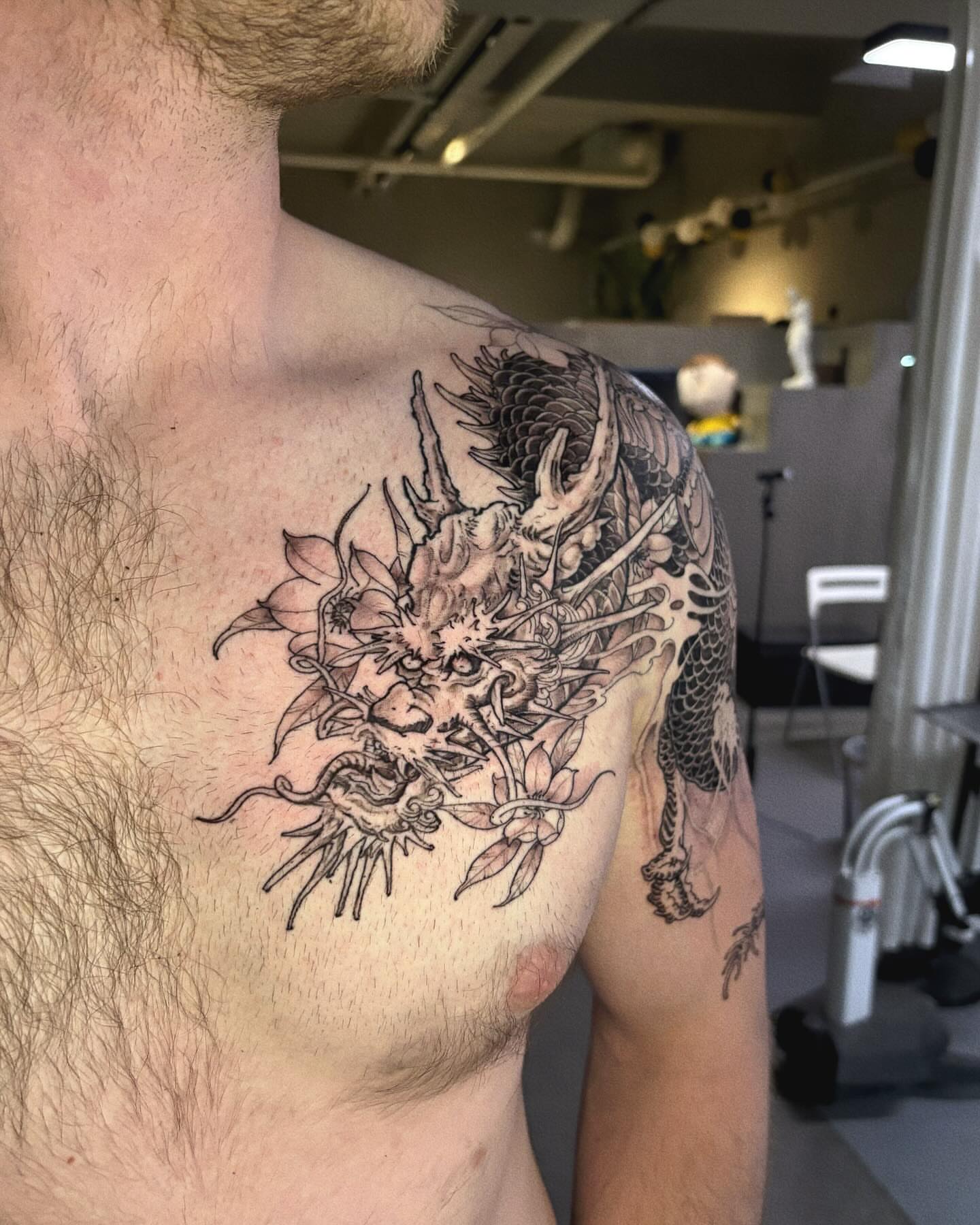 Dragon and flowers japanese irezumi tattoo on the shoulder by Duo