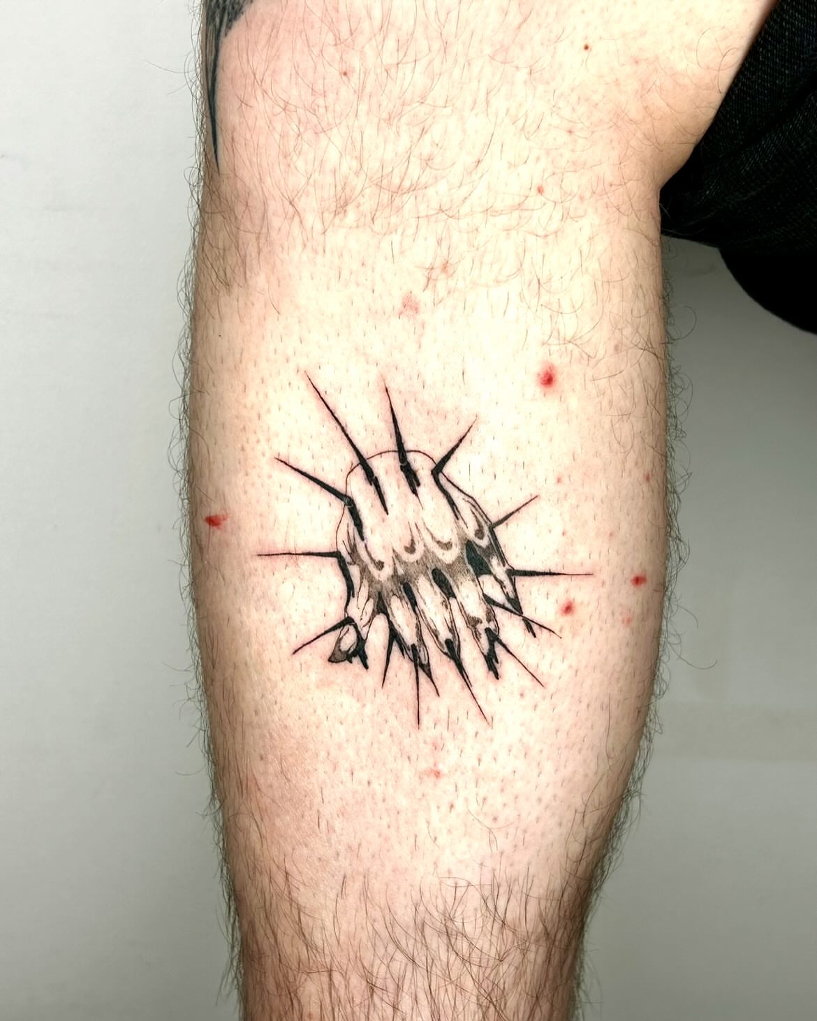 Spiky cluster black and grey tattoo on the forearm by Jadin Nichols