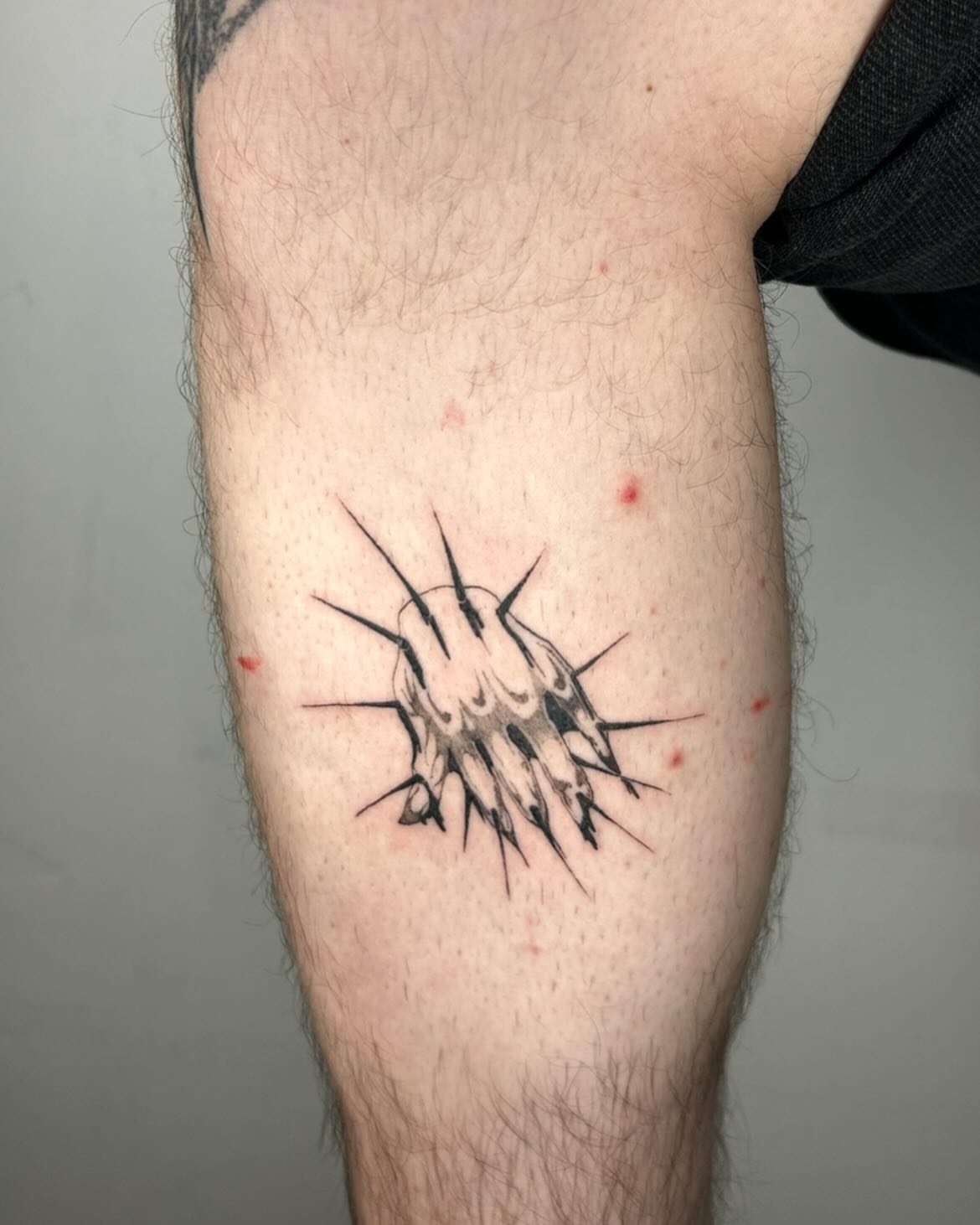 Clawed paw black and grey tattoo on the forearm by Jadin Nichols