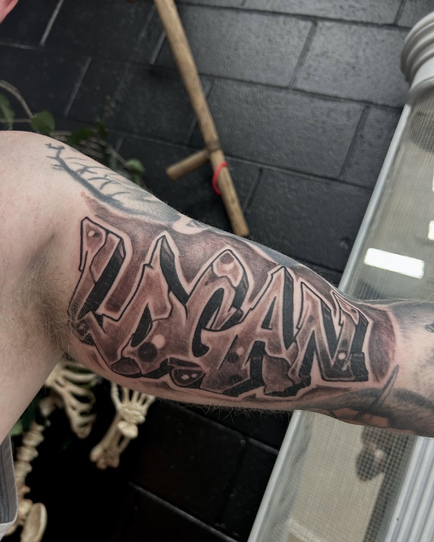 Graffiti-style text lettering script tattoo on the forearm by Josh Williams, Chattanooga, Tennessee