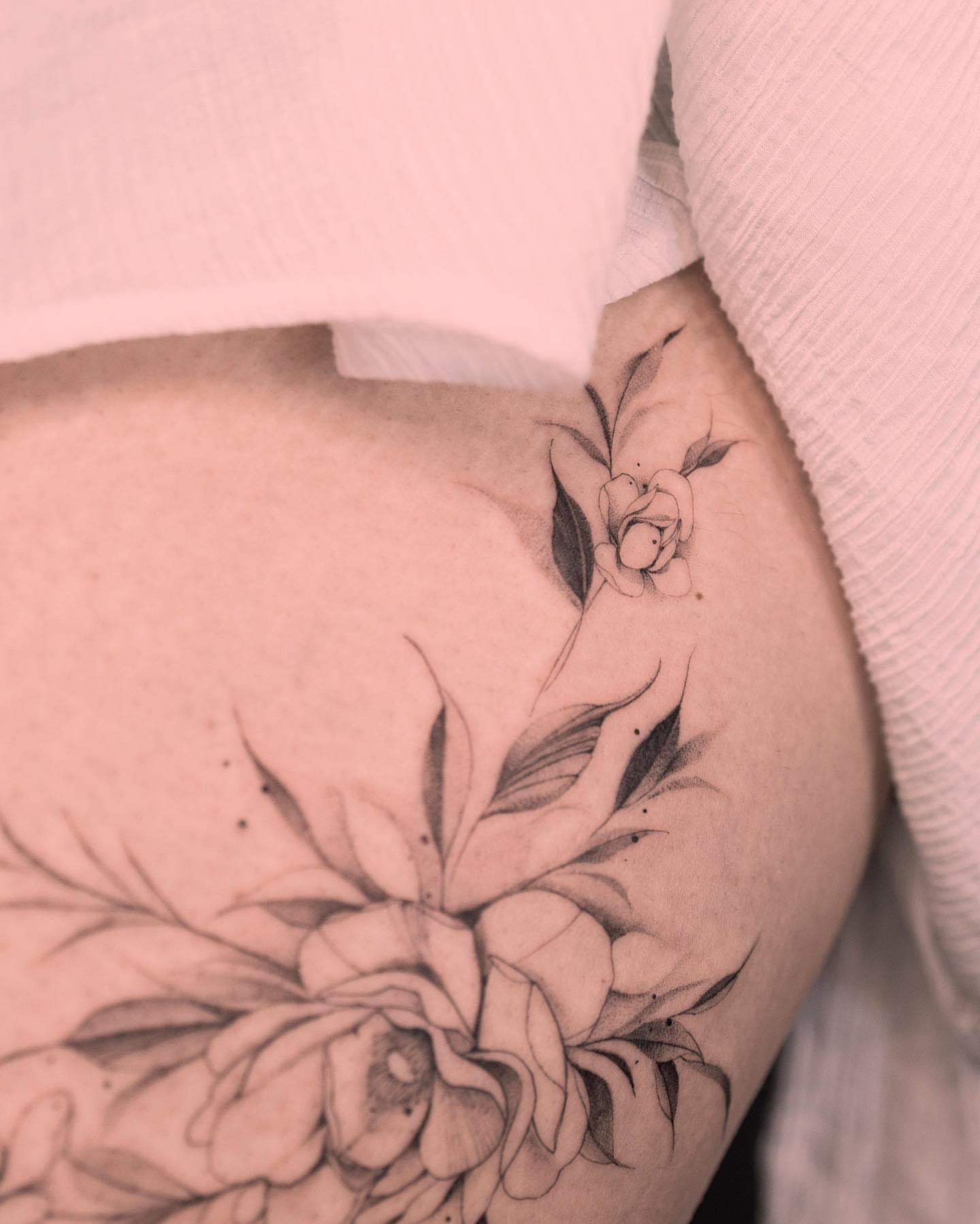 Floral black and grey tattoo on the torso by Tattooist hea