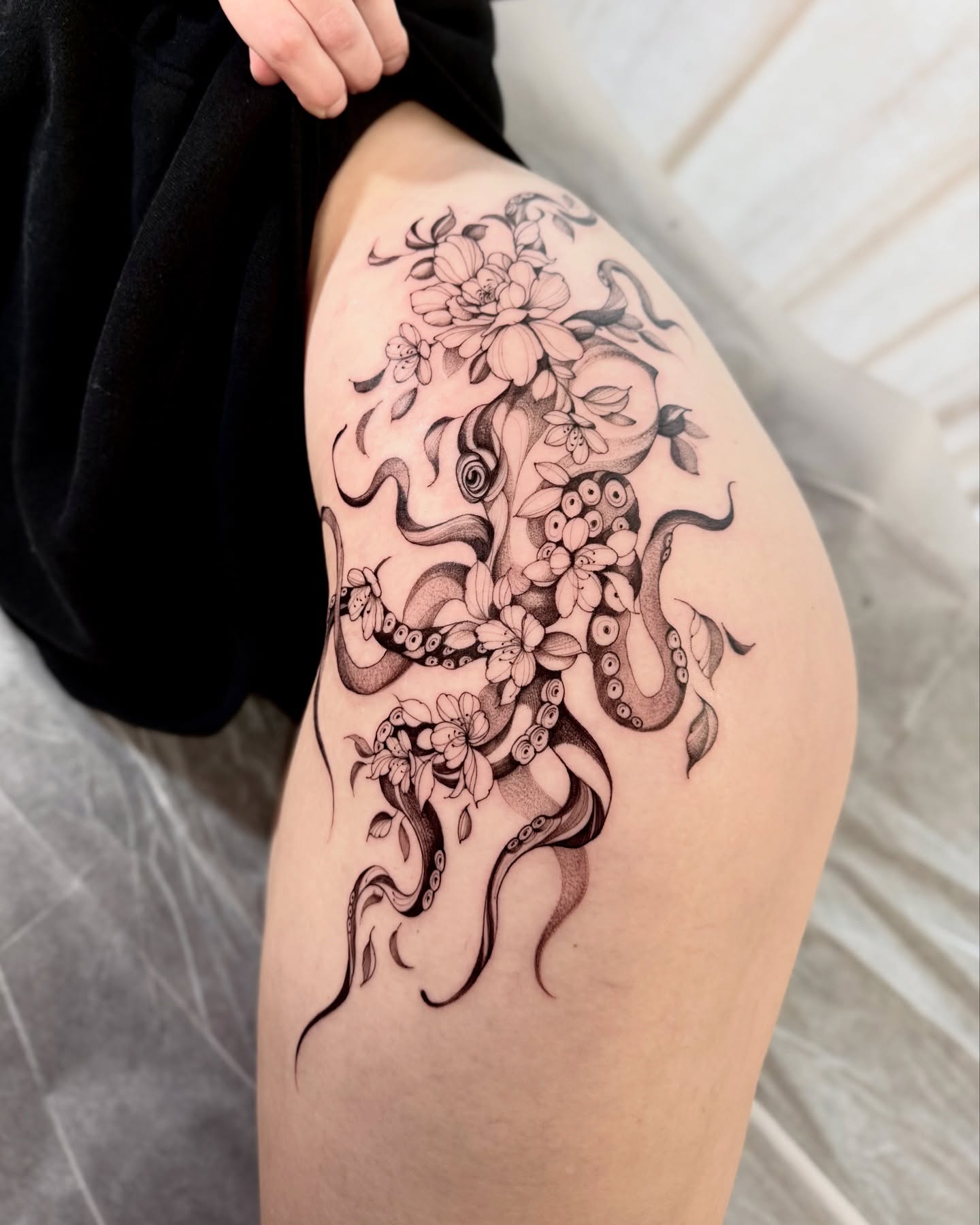 Octopus and flowers dotwork tattoo on the thigh by Dung Ngo