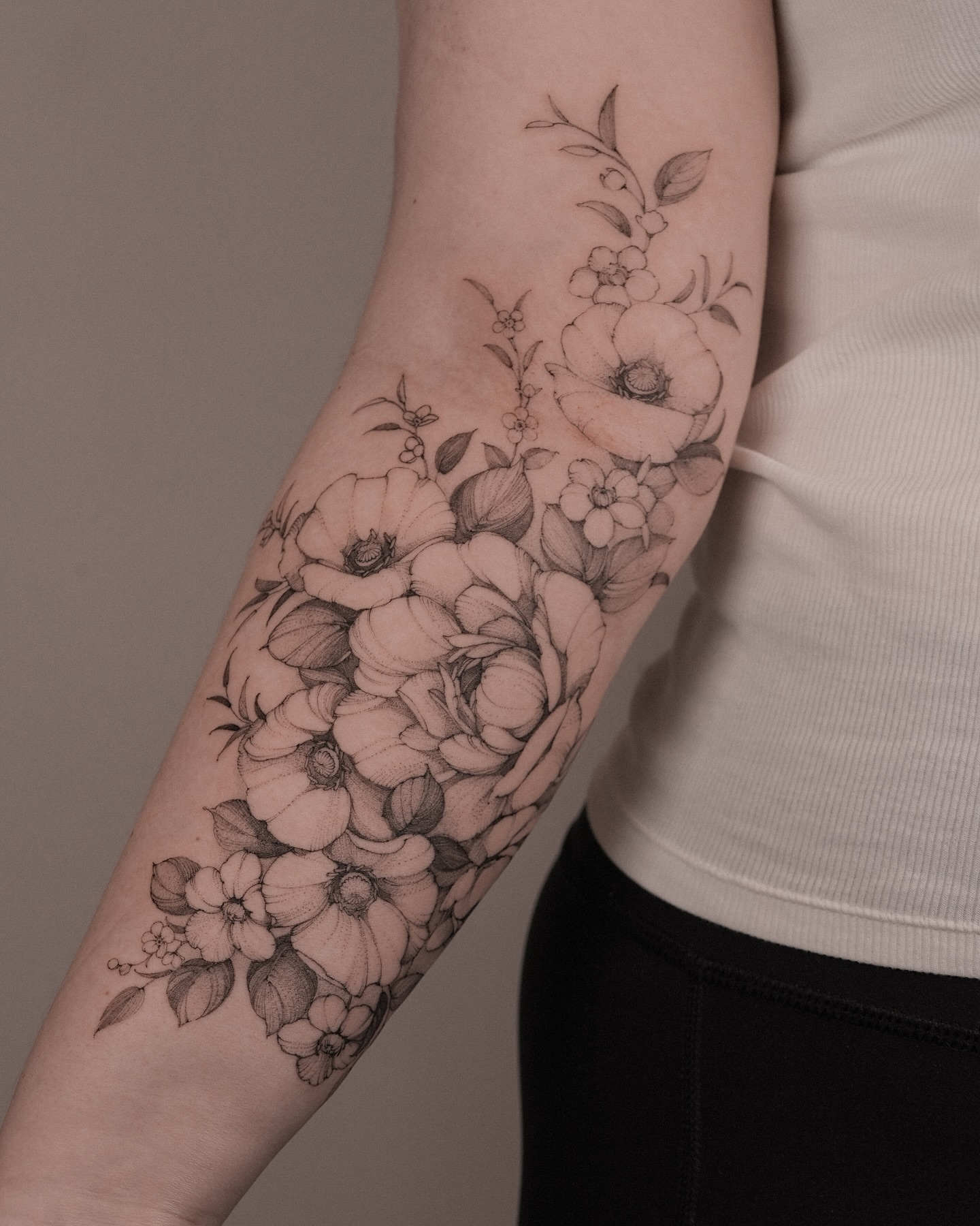 Floral bouquet realism tattoo on the forearm by Mary Shekh