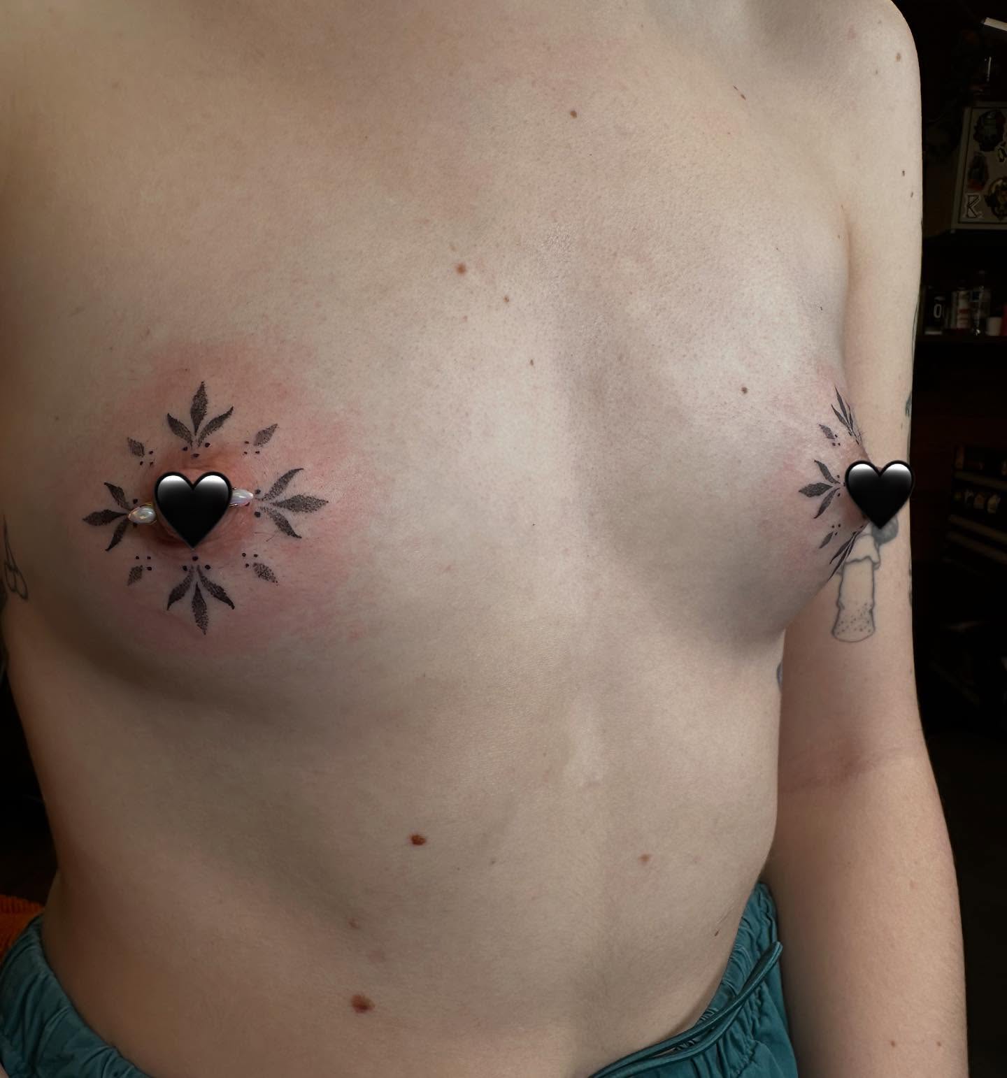 Heart with floral details black and grey tattoo on the chest by Michele Estes