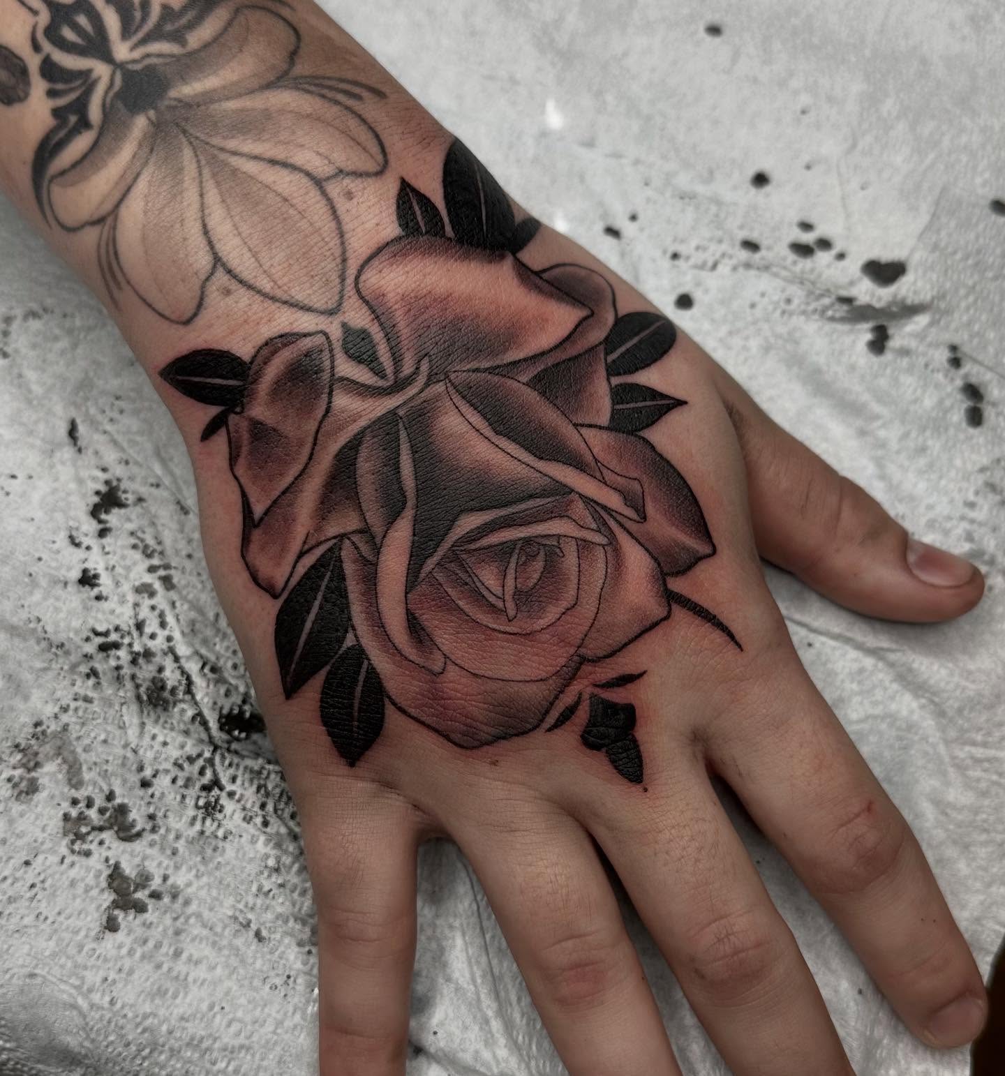 Roses black and grey tattoo on the hand by Son Salem