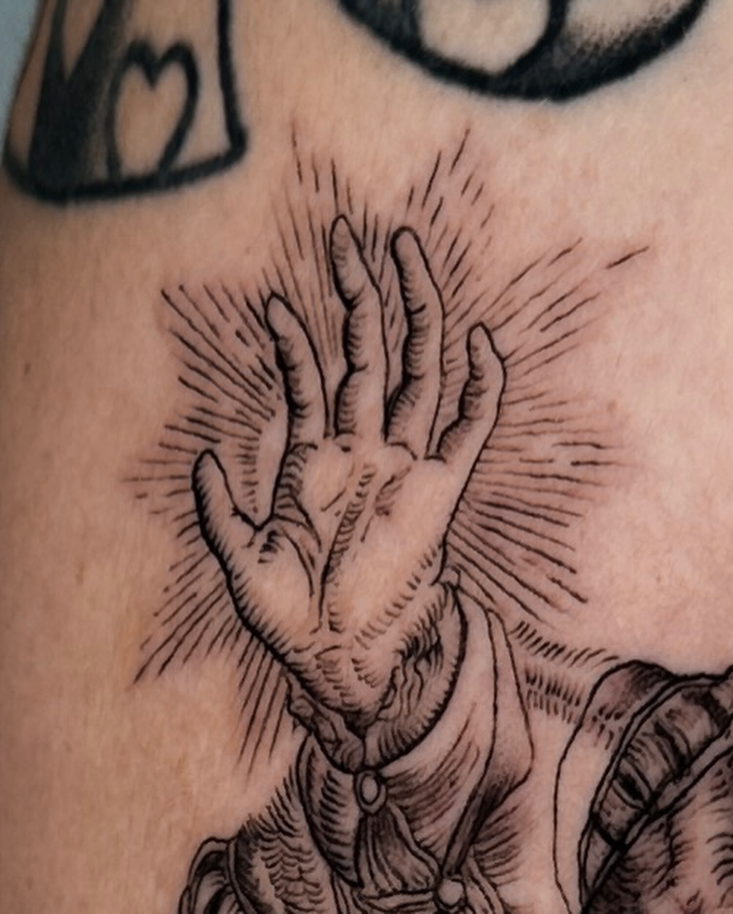 Praying hands black and grey tattoo on the forearm by Tattoo Artist Los Angeles