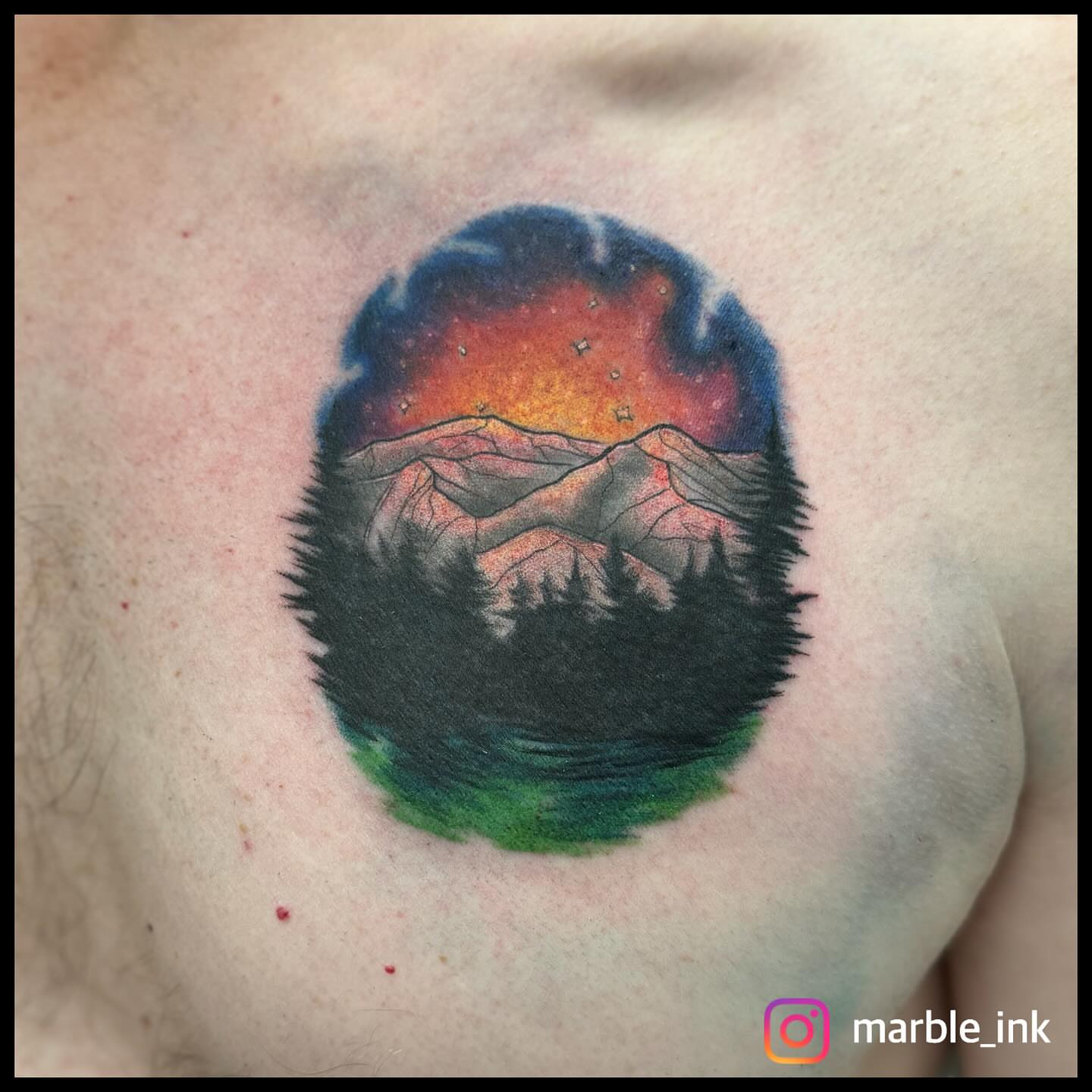 Mountain landscape watercolor tattoo on the chest by Darbi "Marbles"