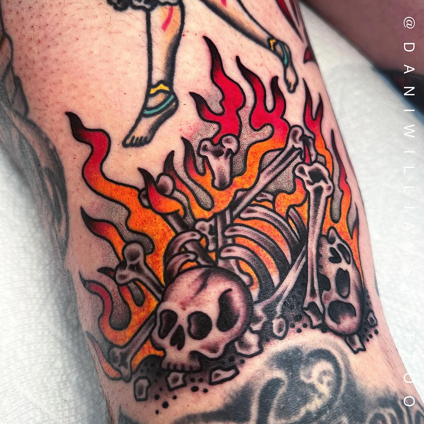 Flaming skeleton American traditional tattoo on the forearm by Dani Johnson