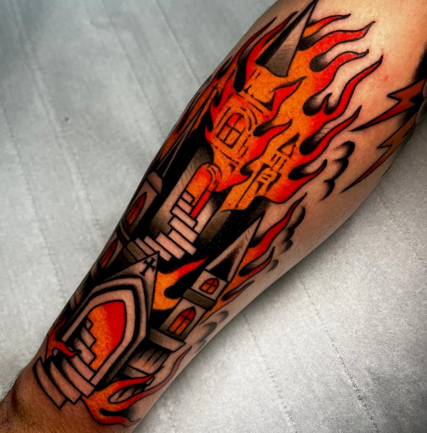 Firehouse American traditional tattoo on the forearm by Hailey Johnson