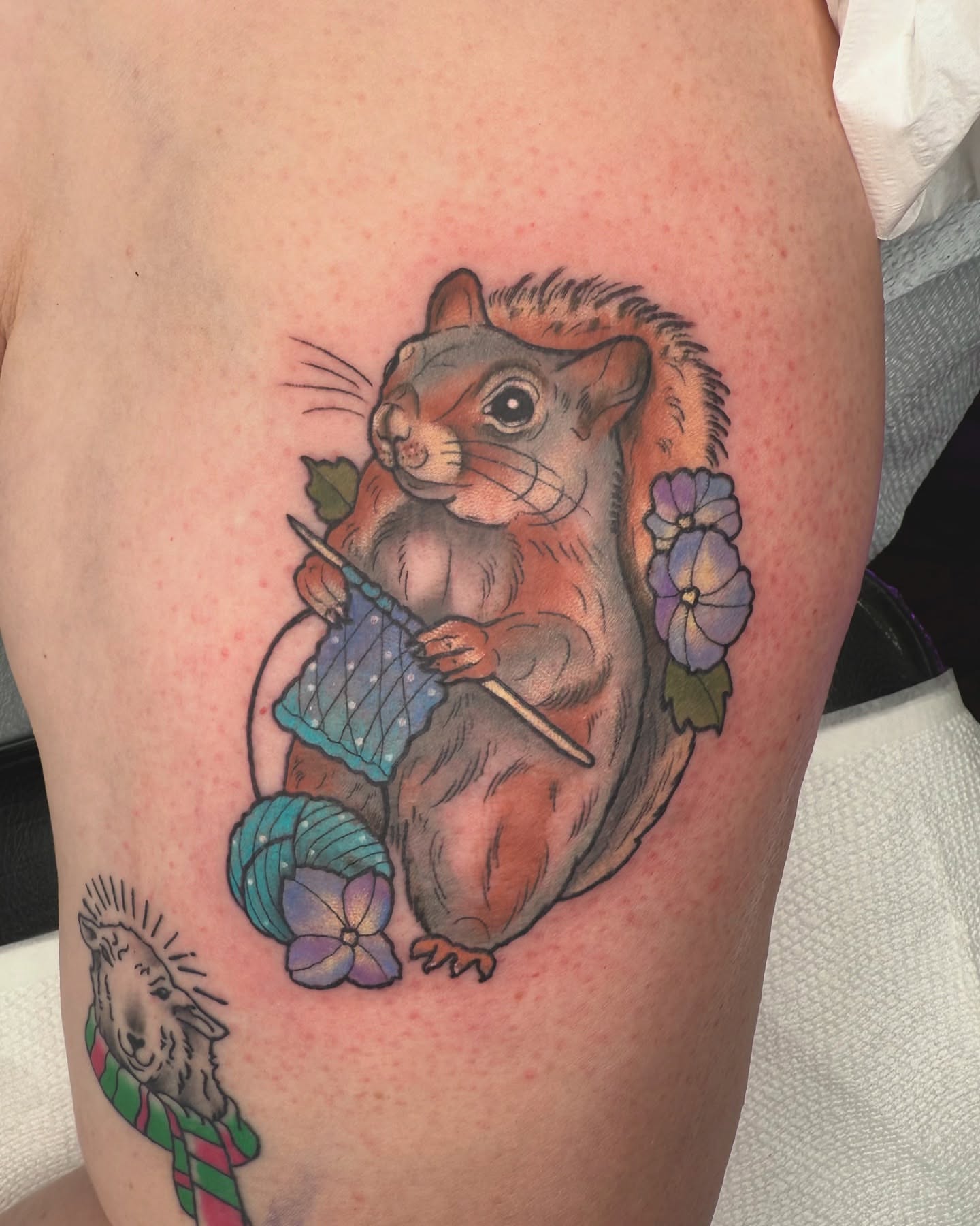Squirrel knitting realism tattoo on the thigh by Caitlin Stairs