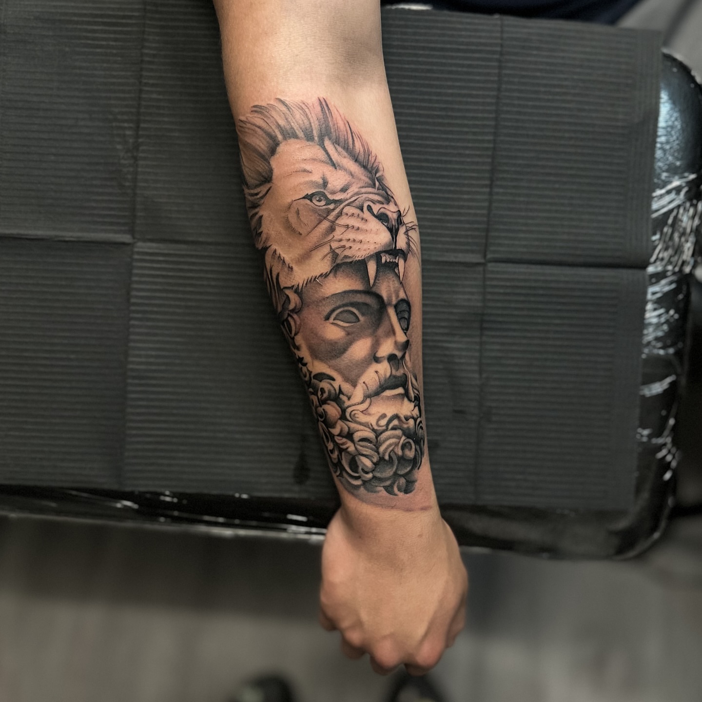 Lion and man realism tattoo on the forearm by mssinderella