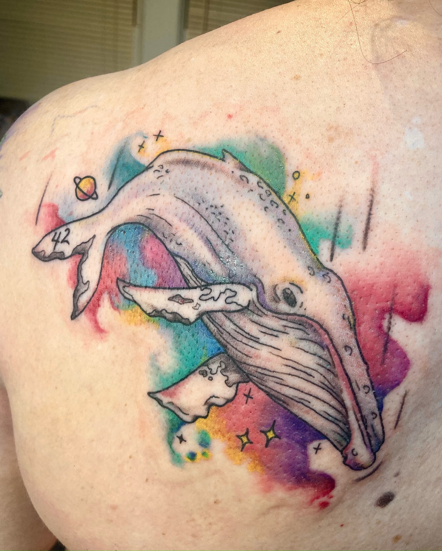Whale watercolor tattoo on the shoulder by Christin Baumgart