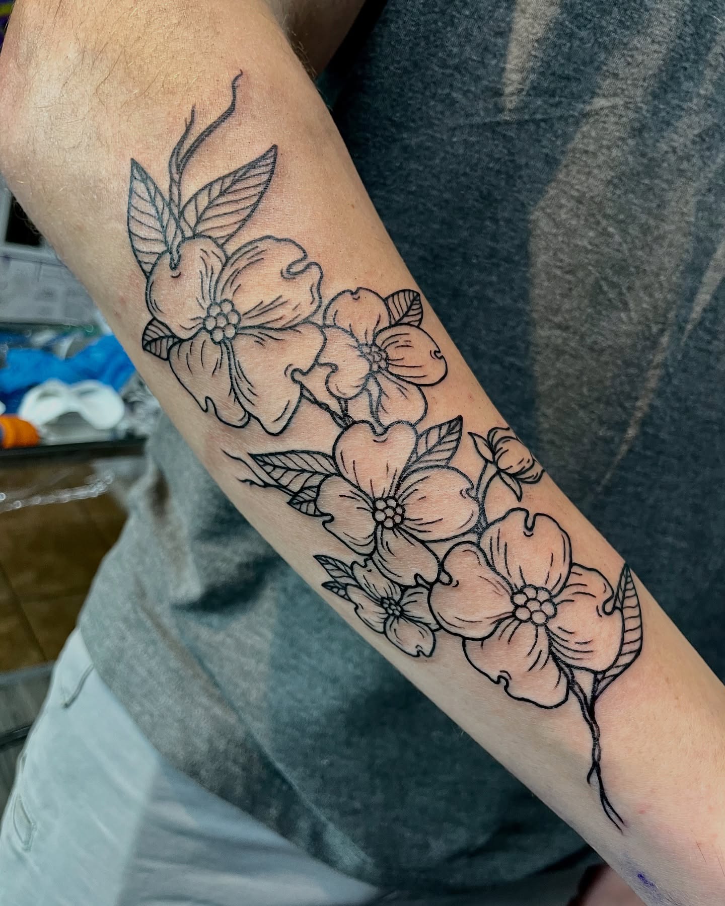 Dogwood flowers black and grey tattoo on the forearm by Christin Baumgart