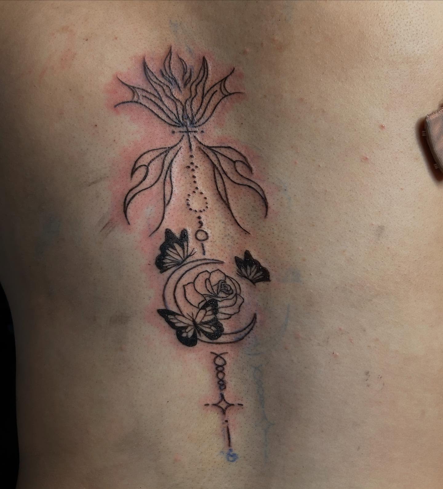 Flower and butterflies dotwork tattoo on the ribs by Detroit tattoo Artist