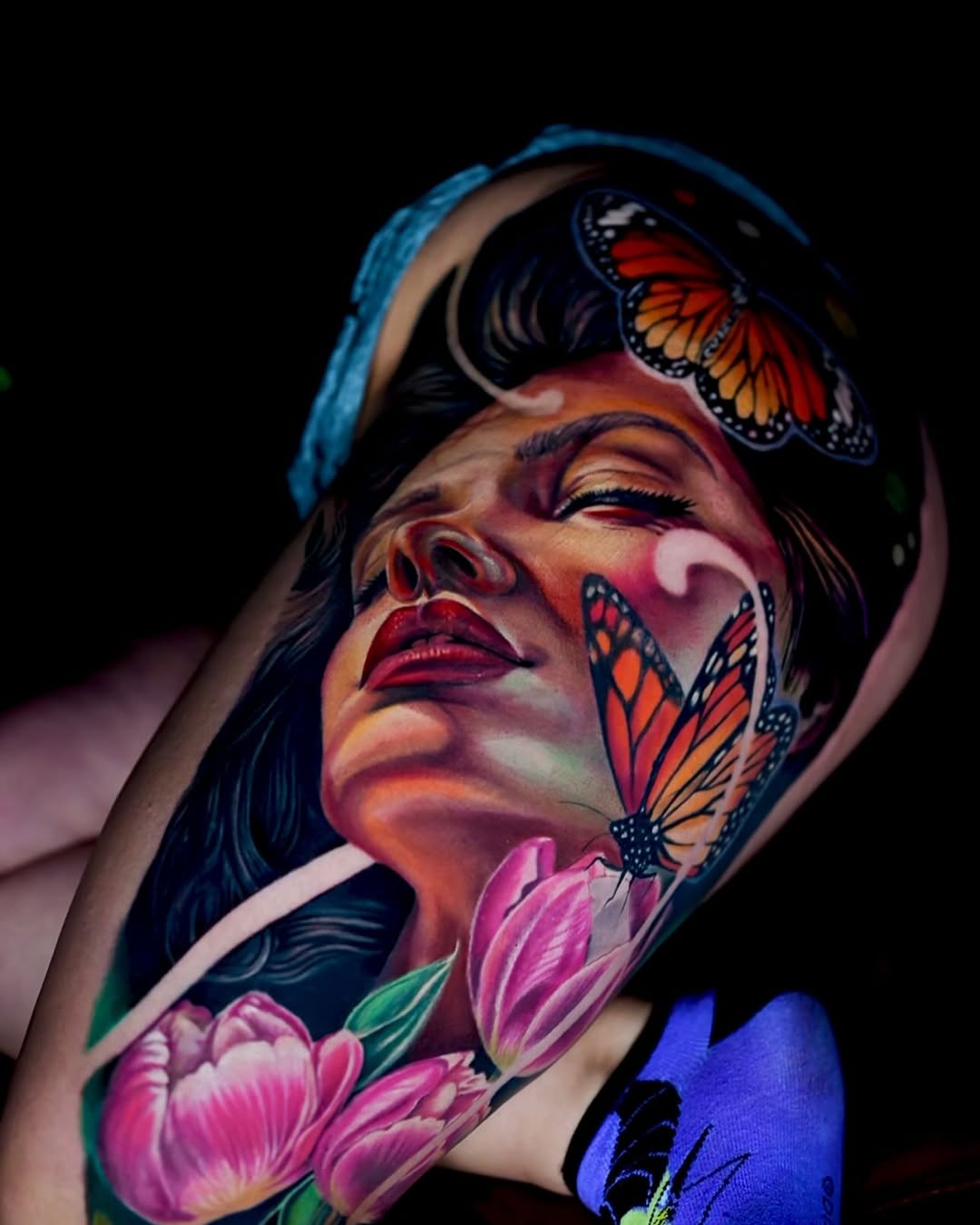 Woman with butterflies and tulips surrealism tattoo on the forearm by Yasmani ramirez