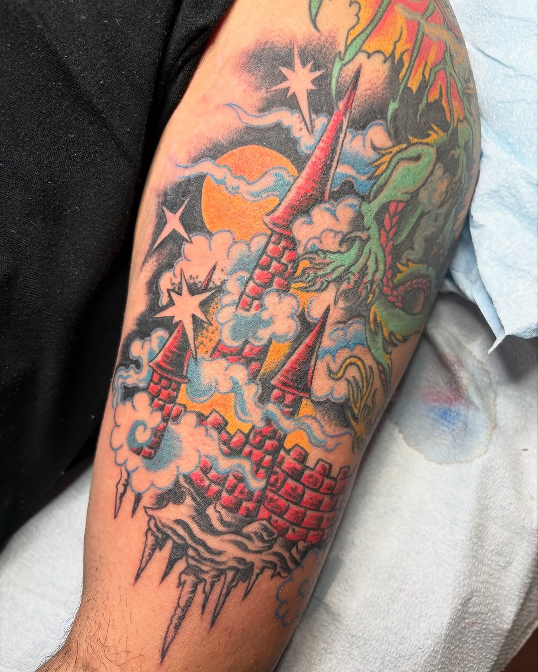 Dragon and castle American traditional tattoo on the forearm by Gabi Elia