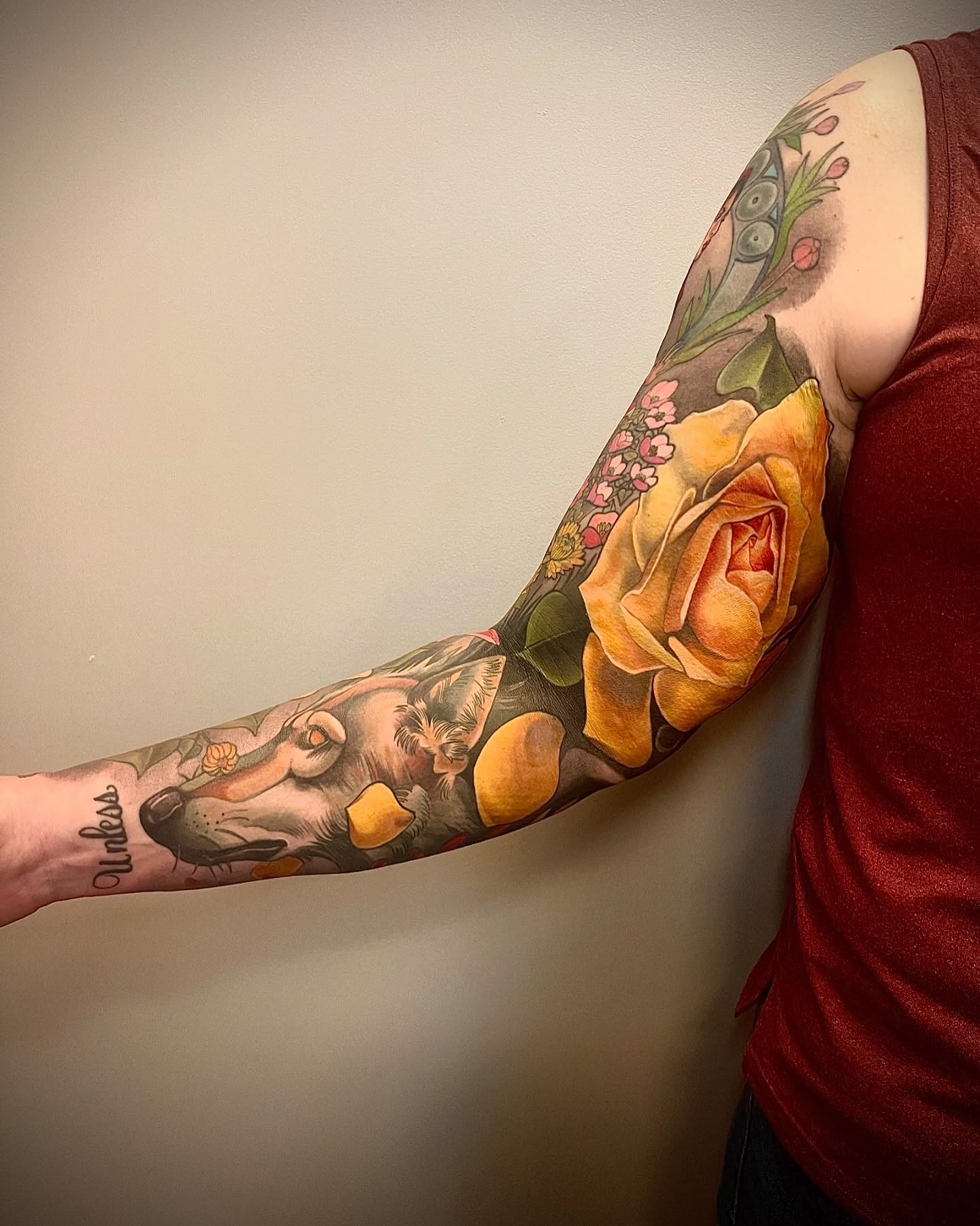Dog and rose realism tattoo on the forearm by Jessica Brown