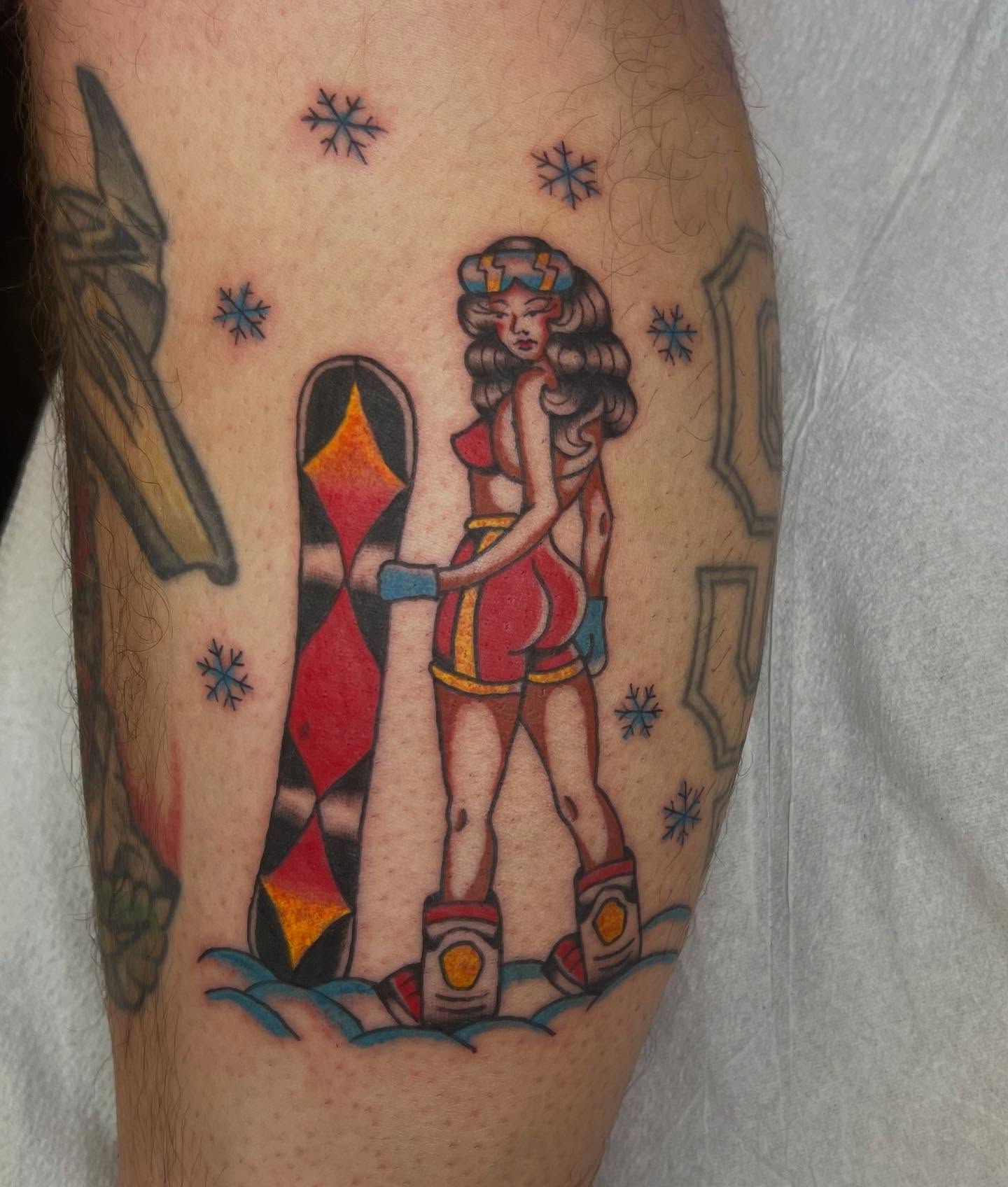 Female character with snowboard American traditional tattoo on the forearm by Erika Donn, Portland, Oregon