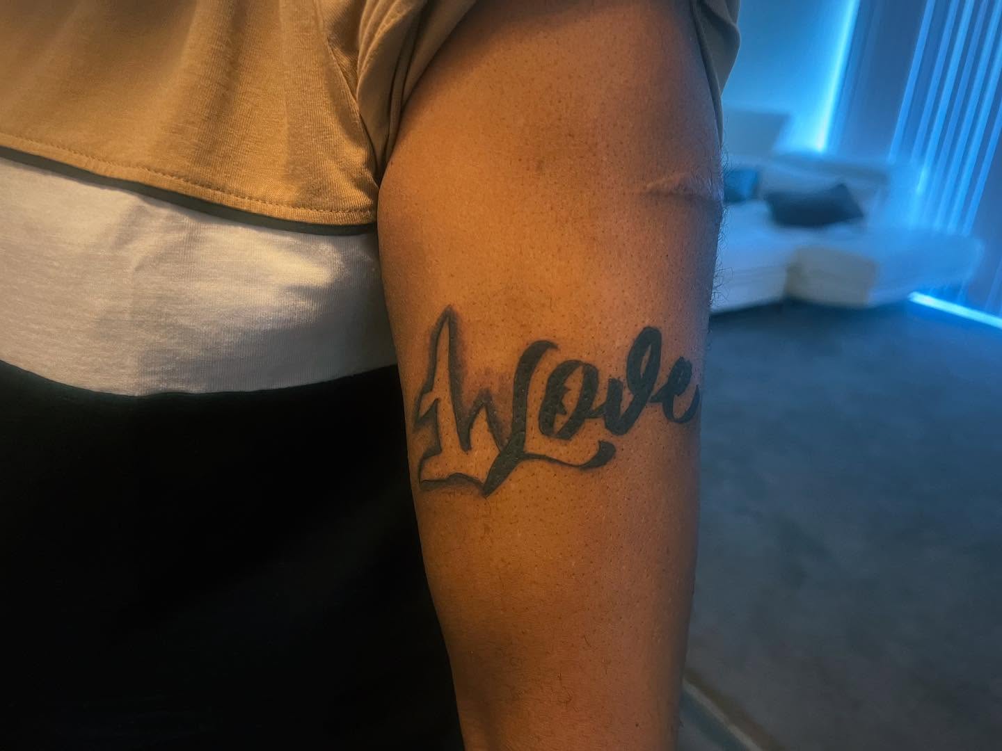Love lettering script tattoo on the forearm by Detroit tattoo Artist