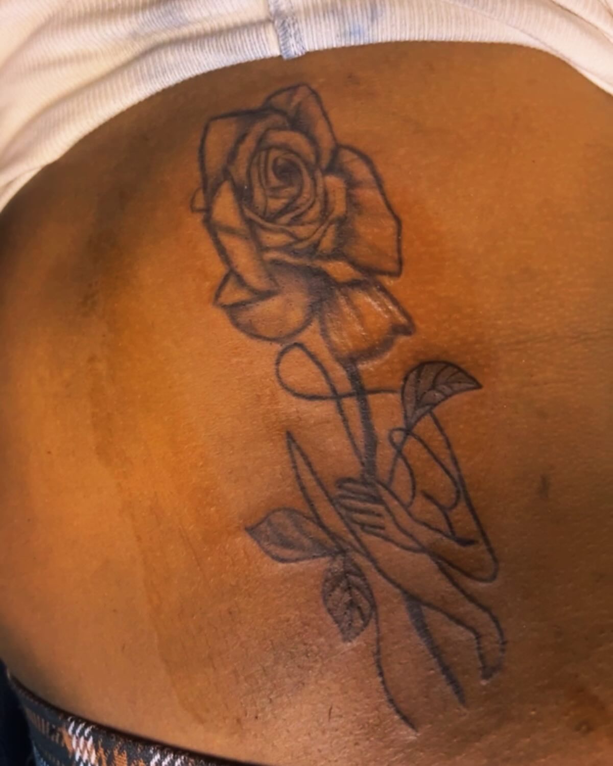Rose black and grey tattoo on the torso by Detroit tattoo Artist