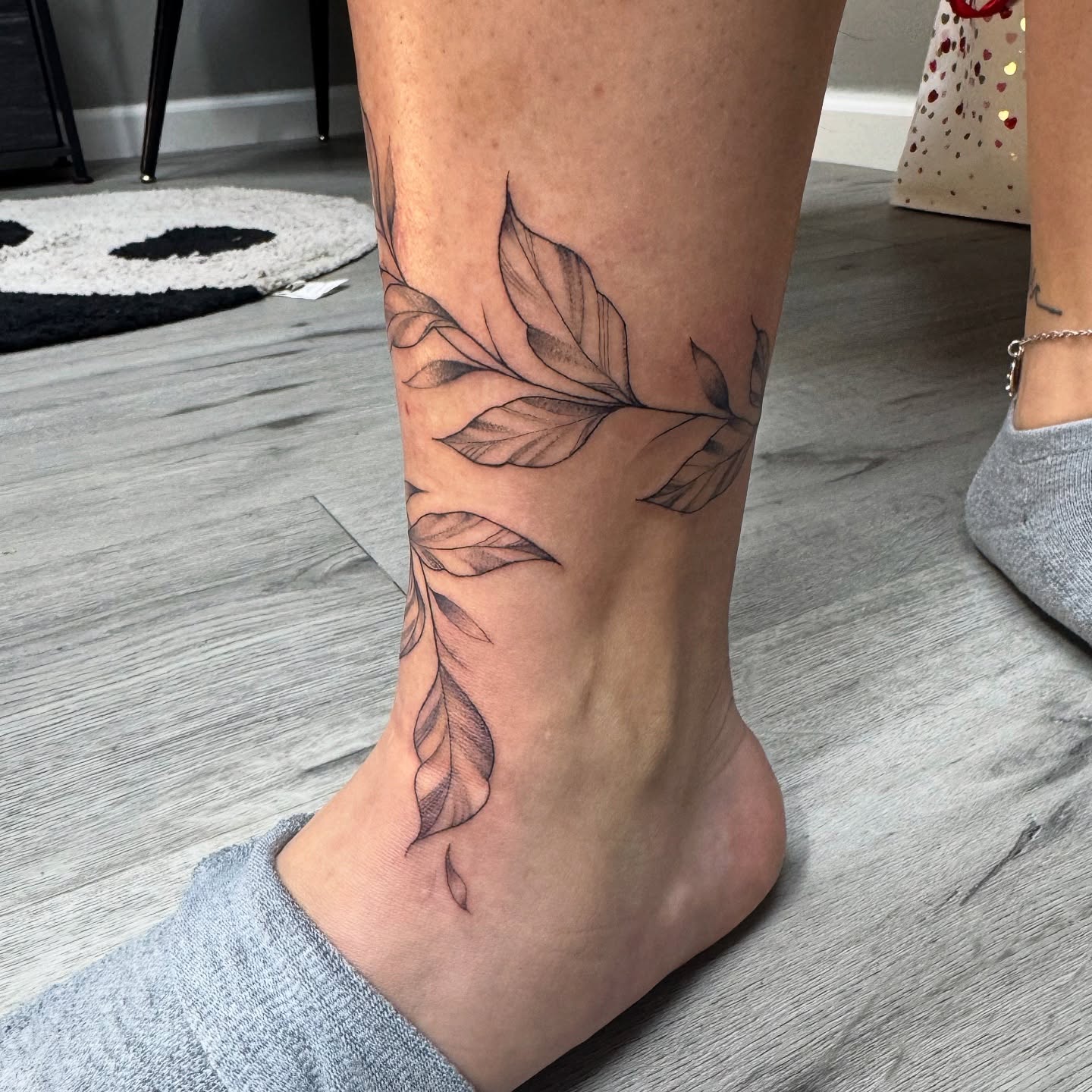 Leaf black and grey tattoo on the calf by Mo Dinero🎰
