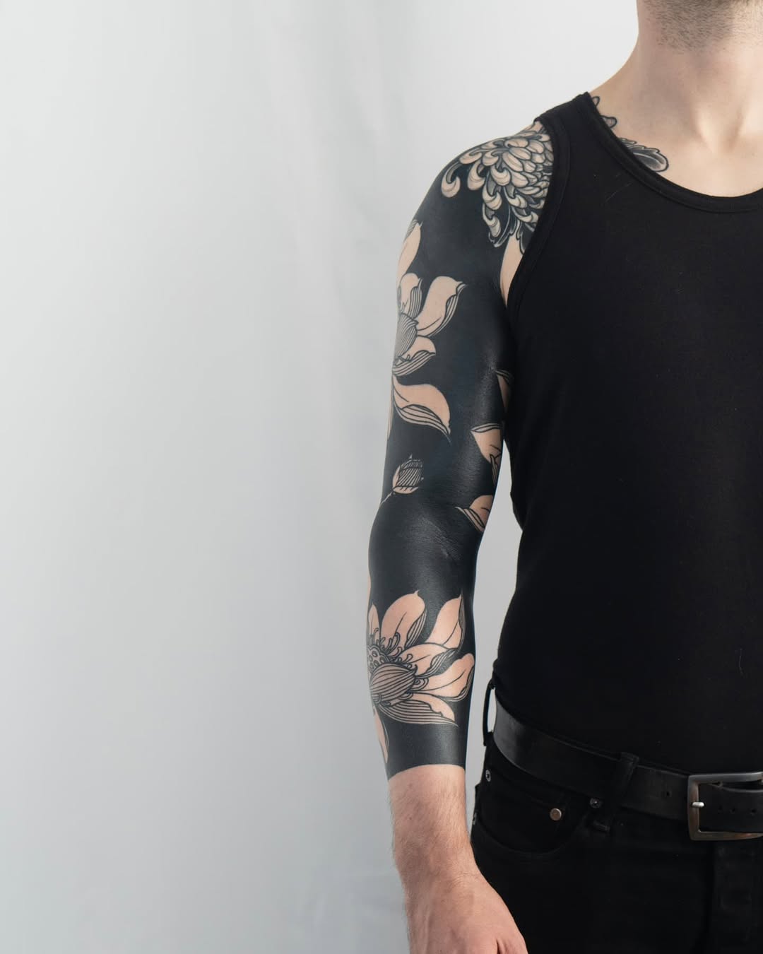 Floral sleeve Japanese tattoo on the upper arm by Kevin Ligabue