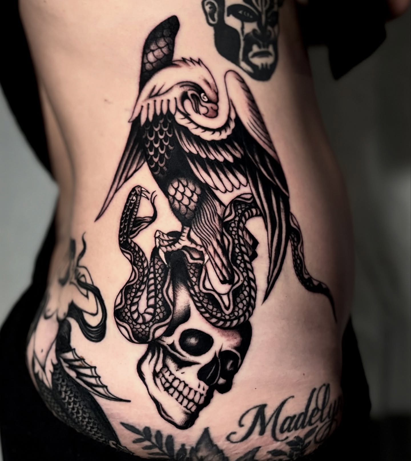 Skull with serpents dark realism tattoo on the ribs by Weston Imhoff