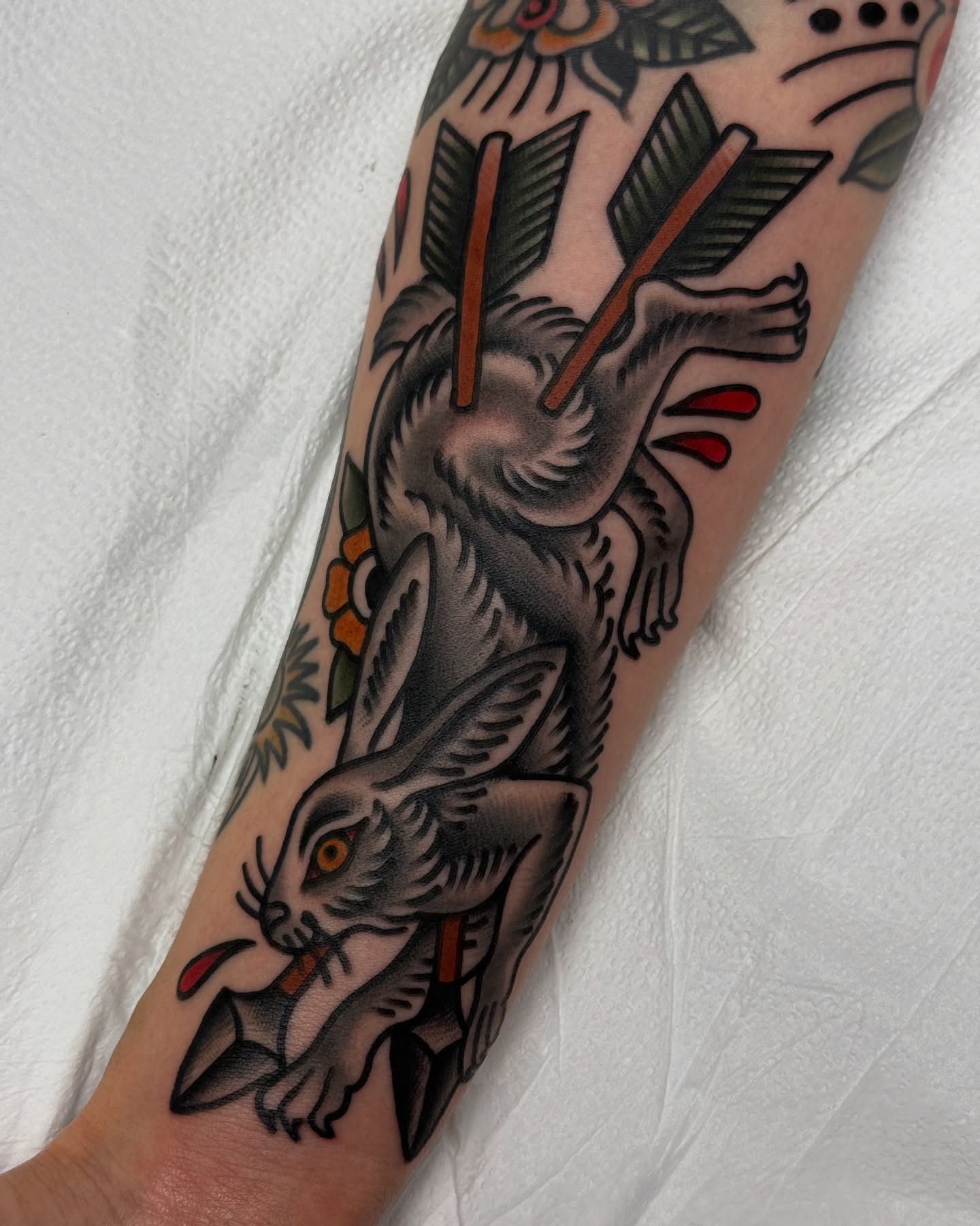 Hare with arrows American traditional tattoo on the forearm by Jordan Allen