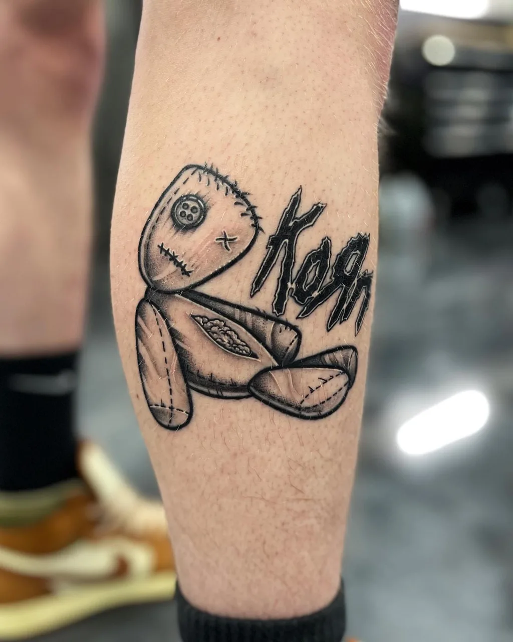 Rag doll black and grey tattoo on the forearm by Adam Silfies