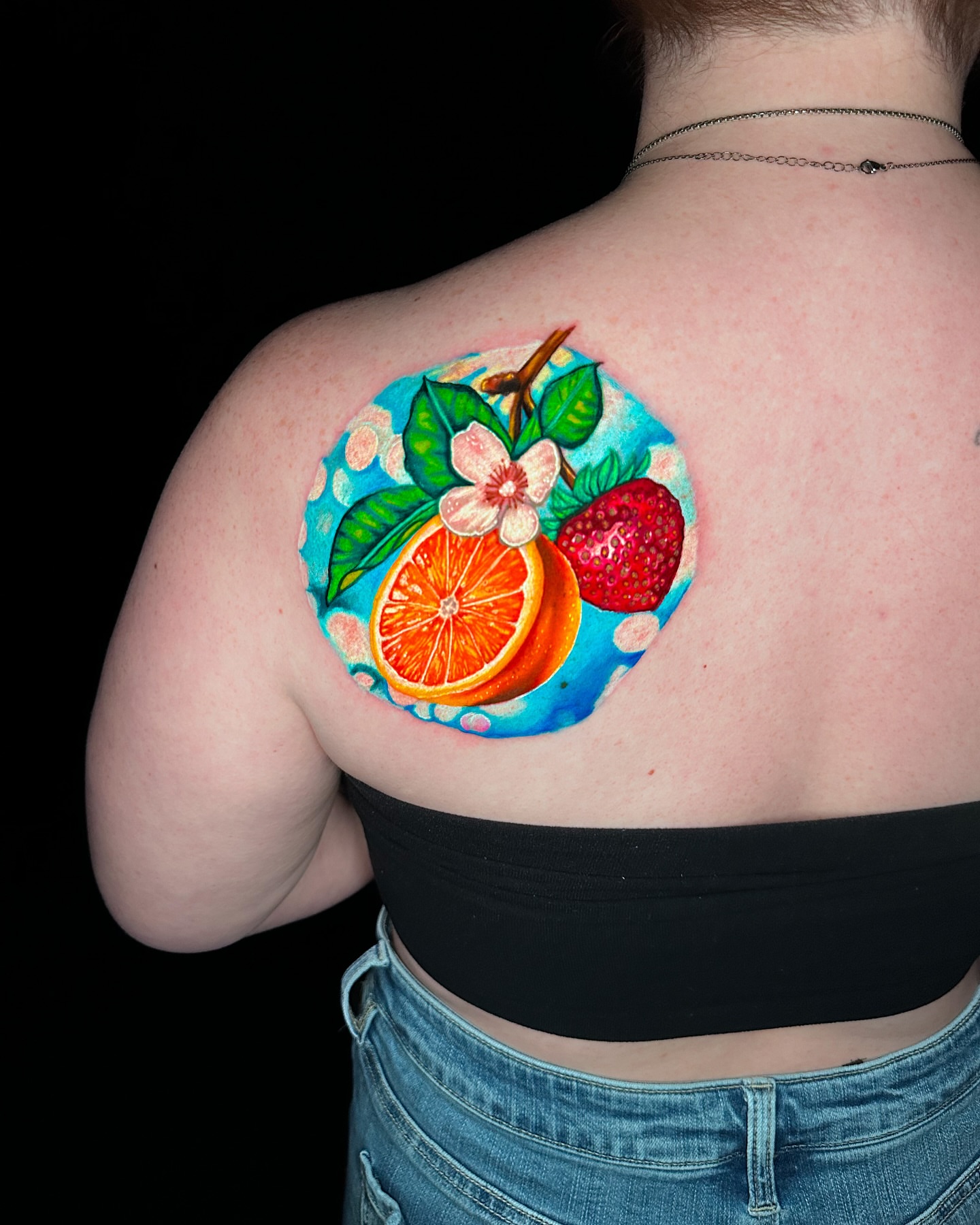 Fruit and flower realism tattoo on the shoulder by Goga