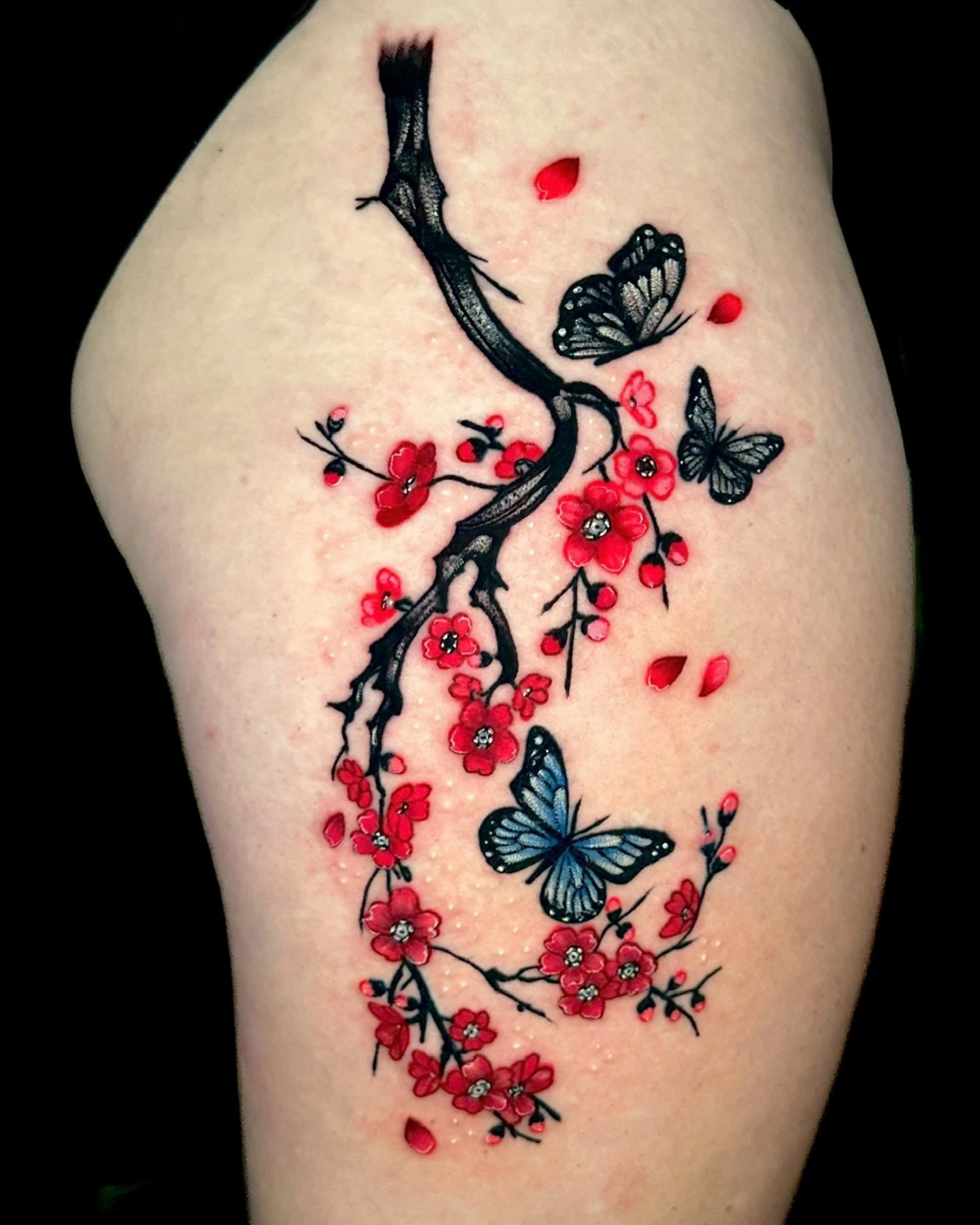 Cherry blossoms and butterflies japanese irezumi tattoo on the thigh by Goga