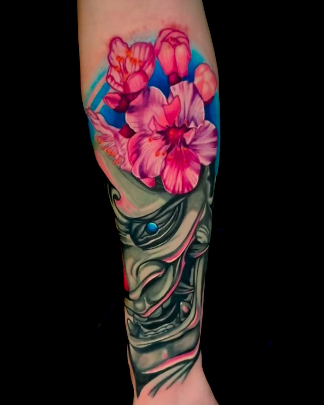 Cherry blossoms watercolor tattoo on the forearm by Goga