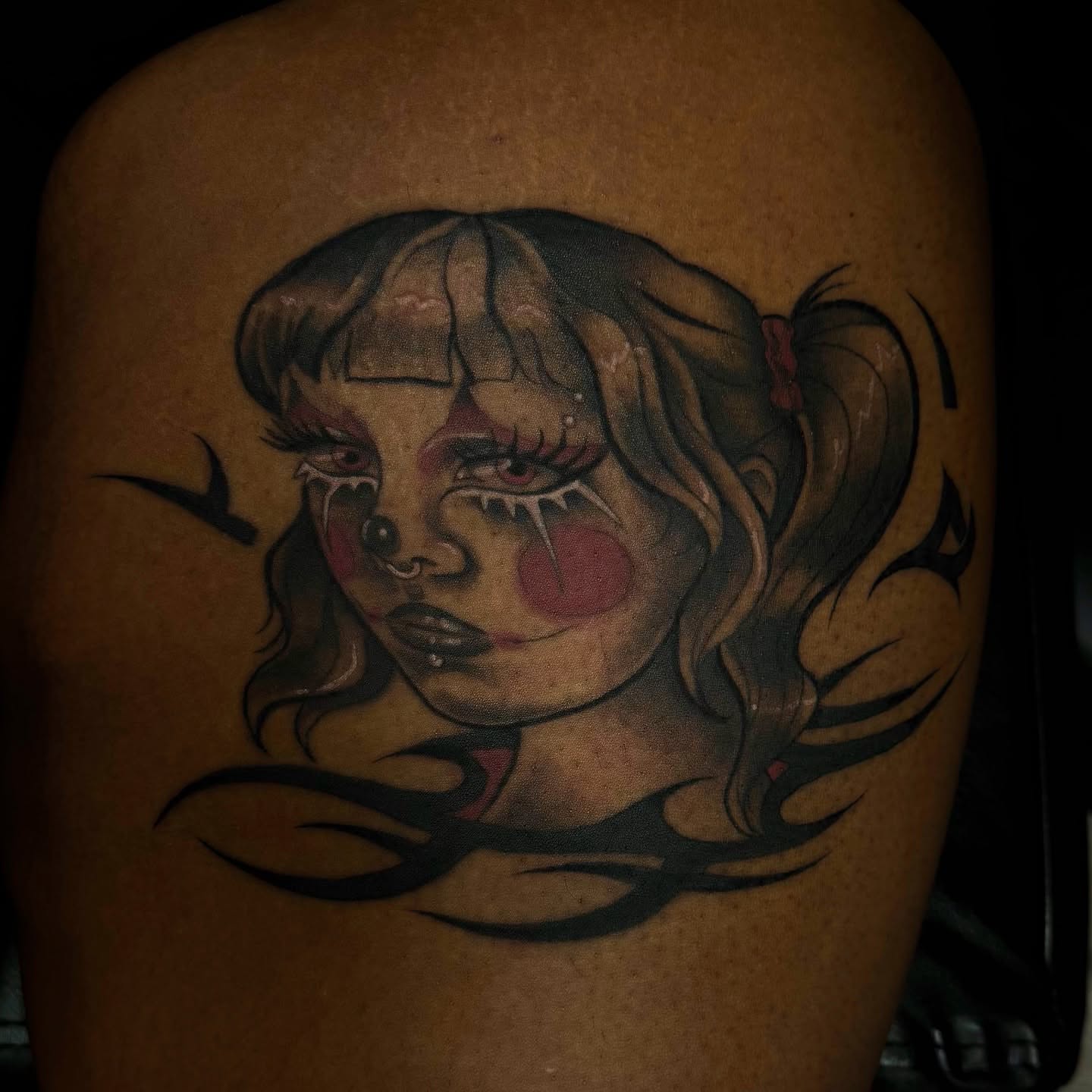 Girl with clown makeup dark realism tattoo on the shoulder by Mags🗡️