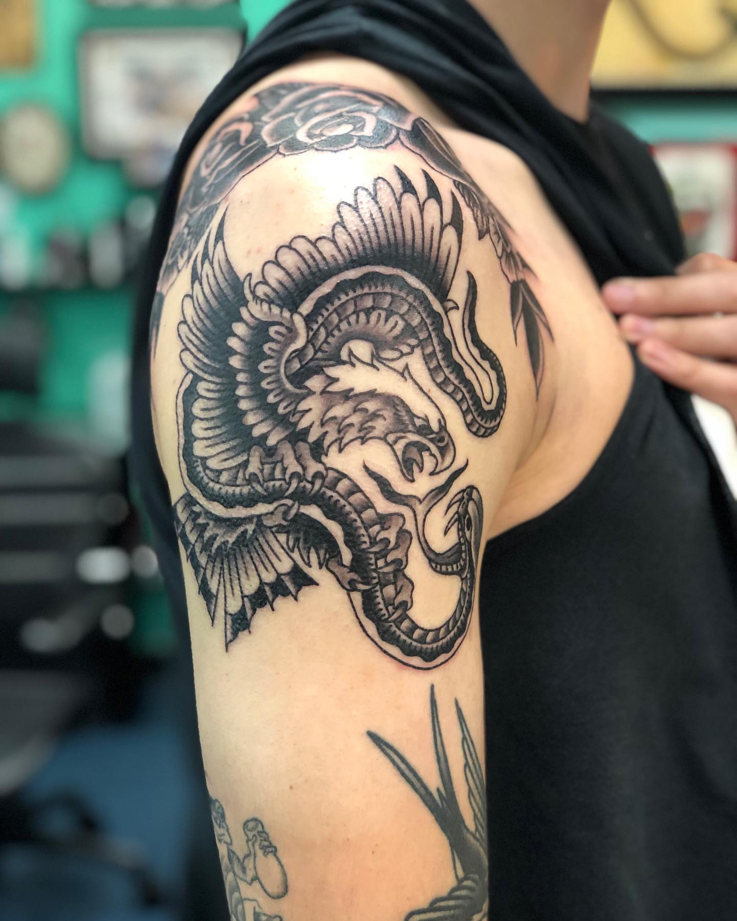 Dragon black and grey tattoo on the shoulder by Matt Klass