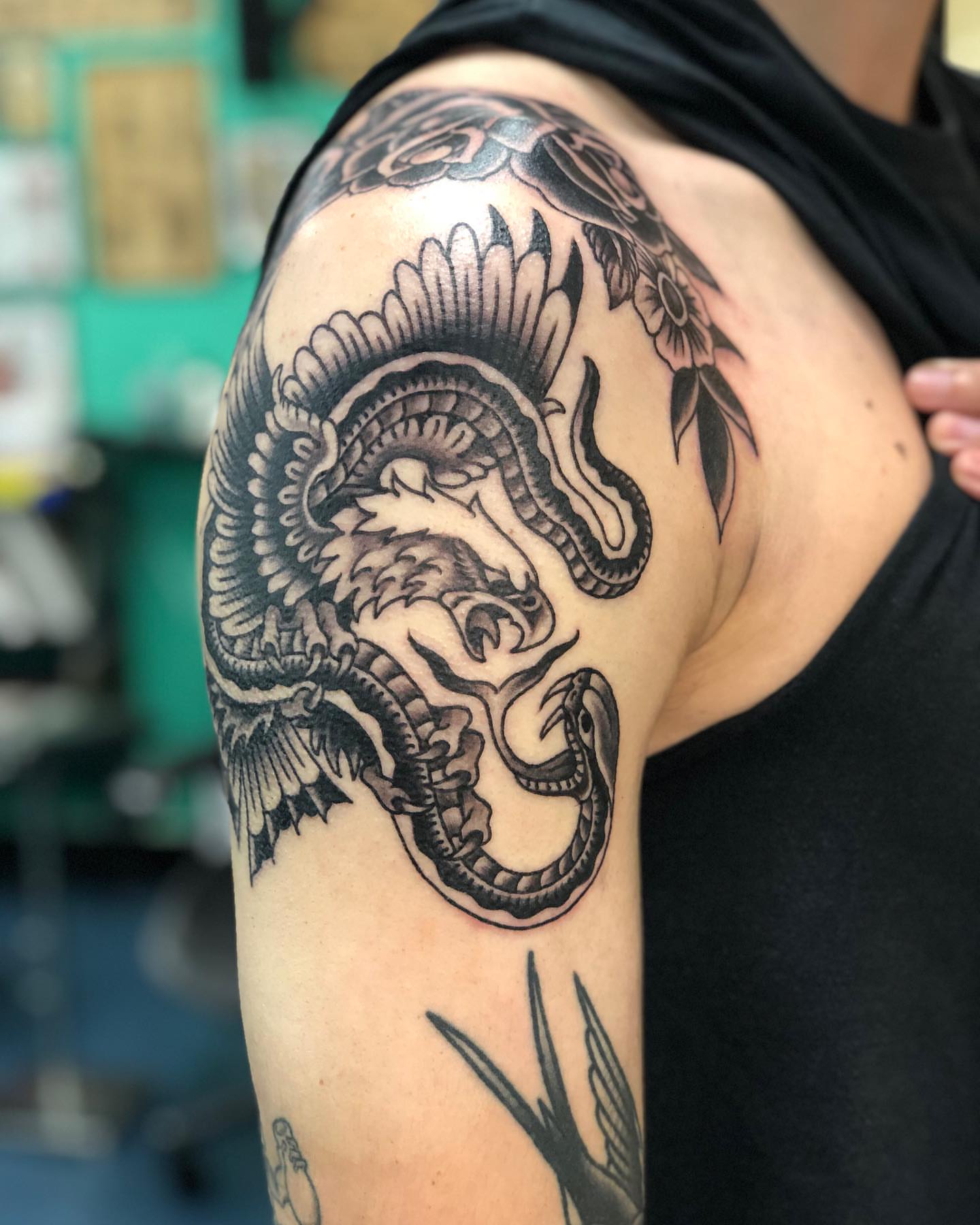 Dragon black and grey tattoo on the shoulder by Matt Klass