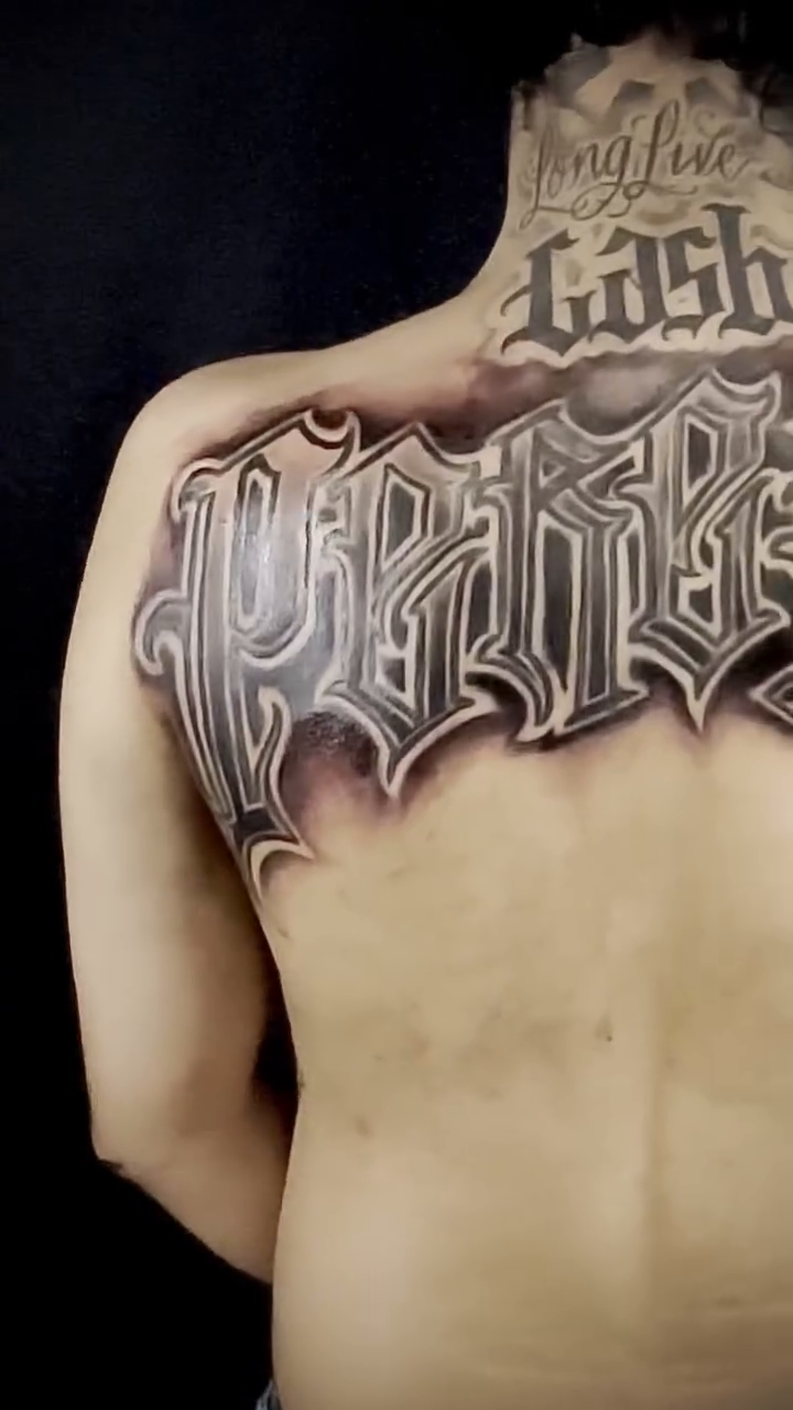 Gothic lettering on back Chicano tattoo on the back by Las vegas tattoo artist