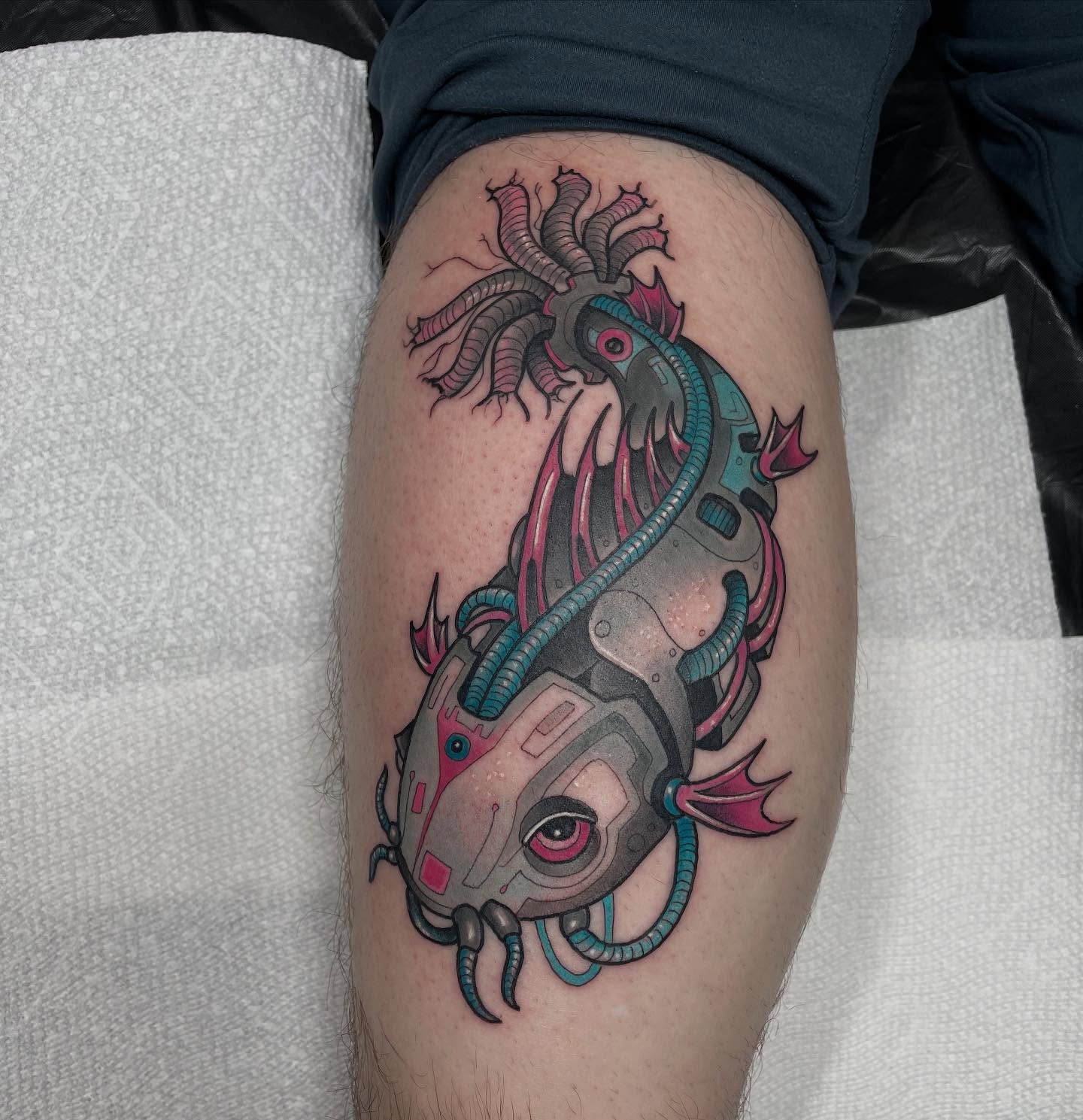 Cyborg fish geometric tattoo on the thigh by Nathan Evans