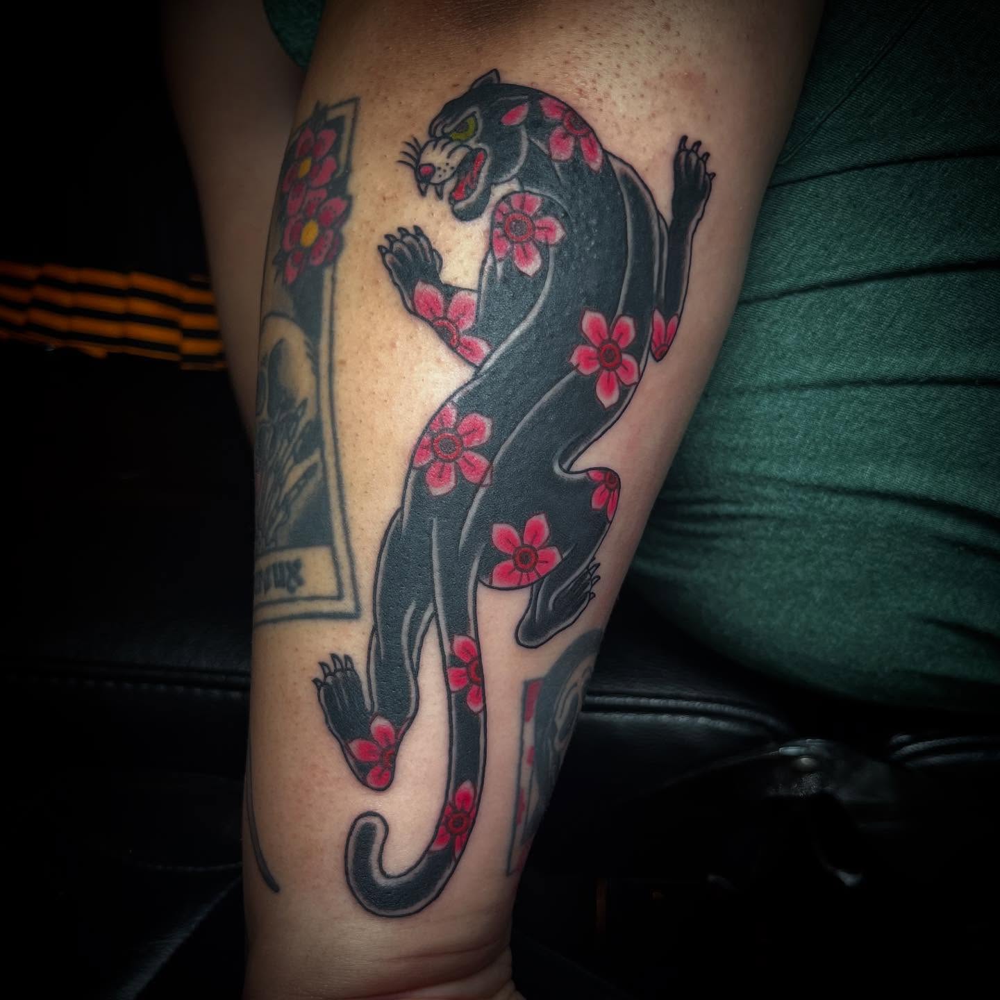 Panther with flowers American traditional tattoo on the forearm by alexandra