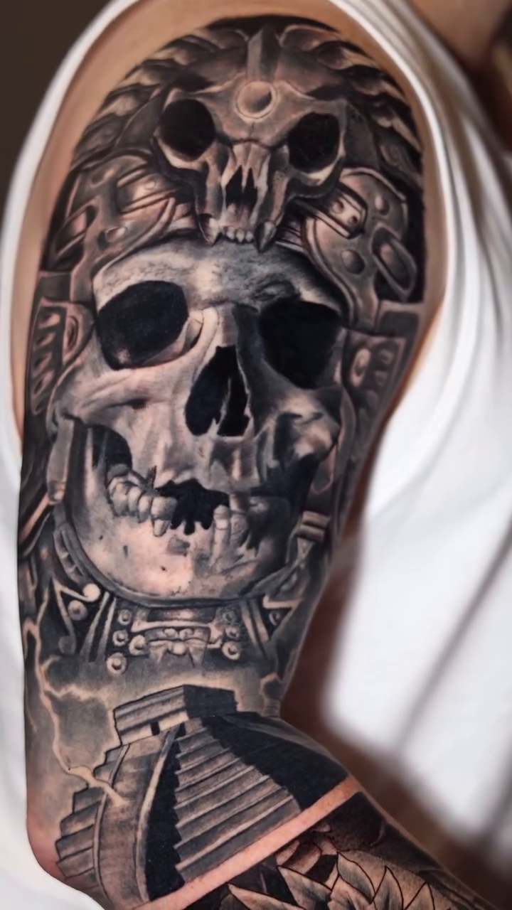 Aztec skull and serpent realism tattoo by Luis Arenas
