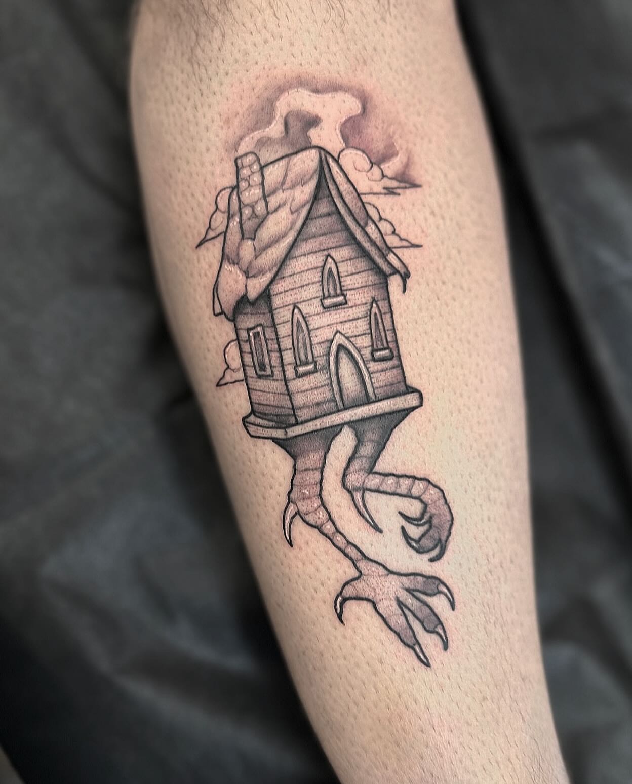Haunted house black and grey tattoo on the forearm by Lawrence Edwards