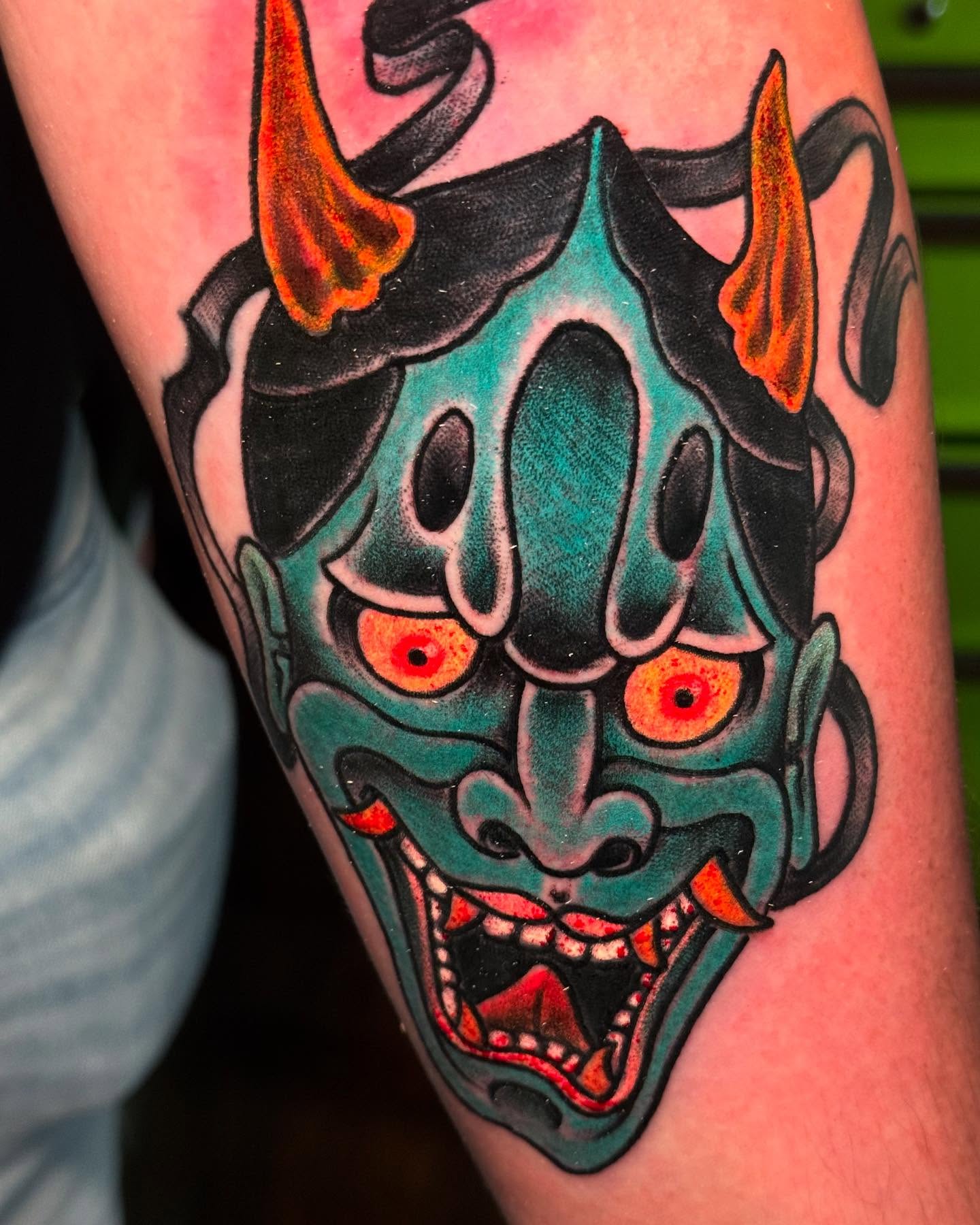 Demon mask American traditional tattoo on the thigh by Edward Choat